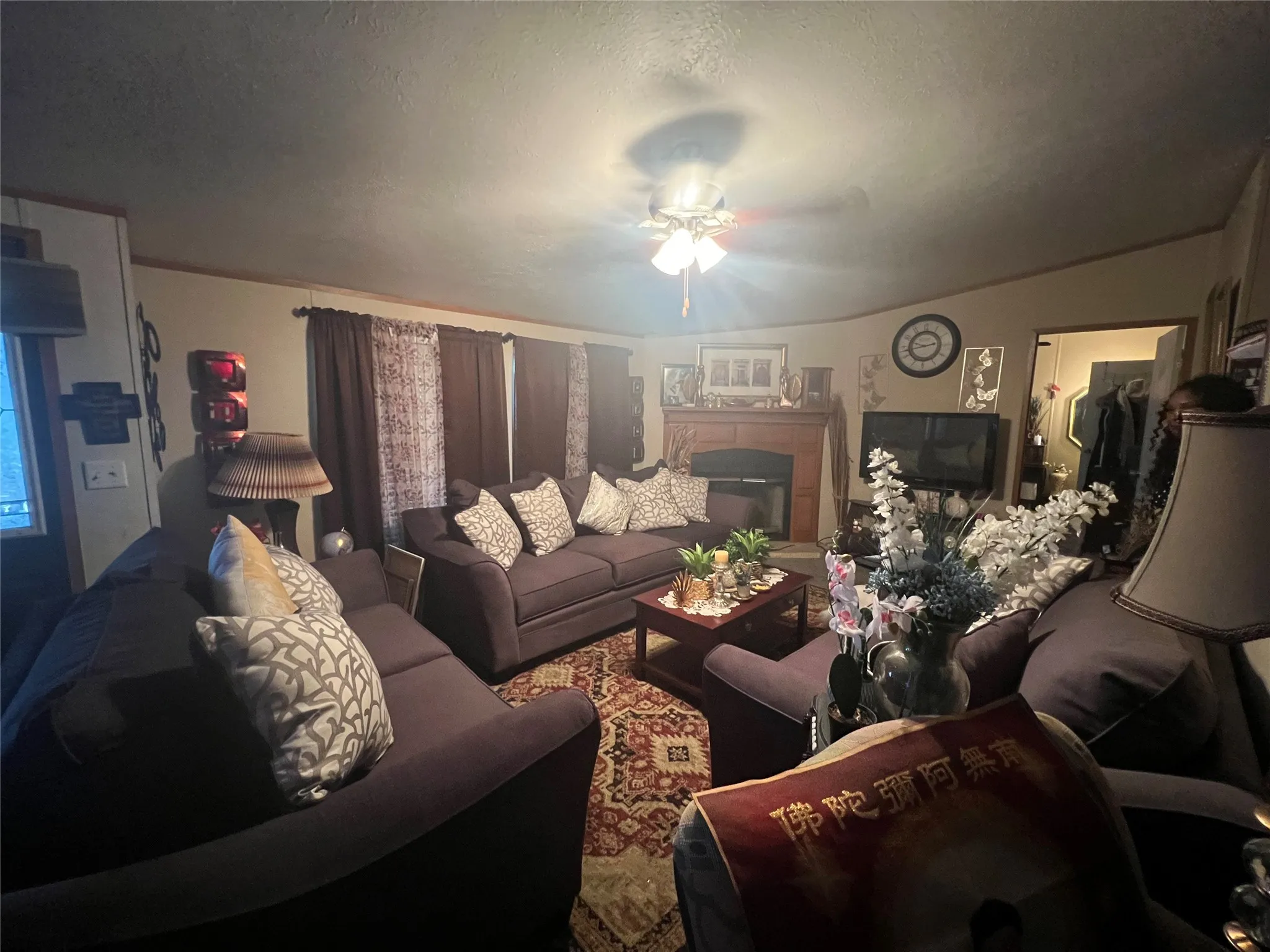 Living space featuring a built-in fireplace, ceiling fan, and recessed lighting