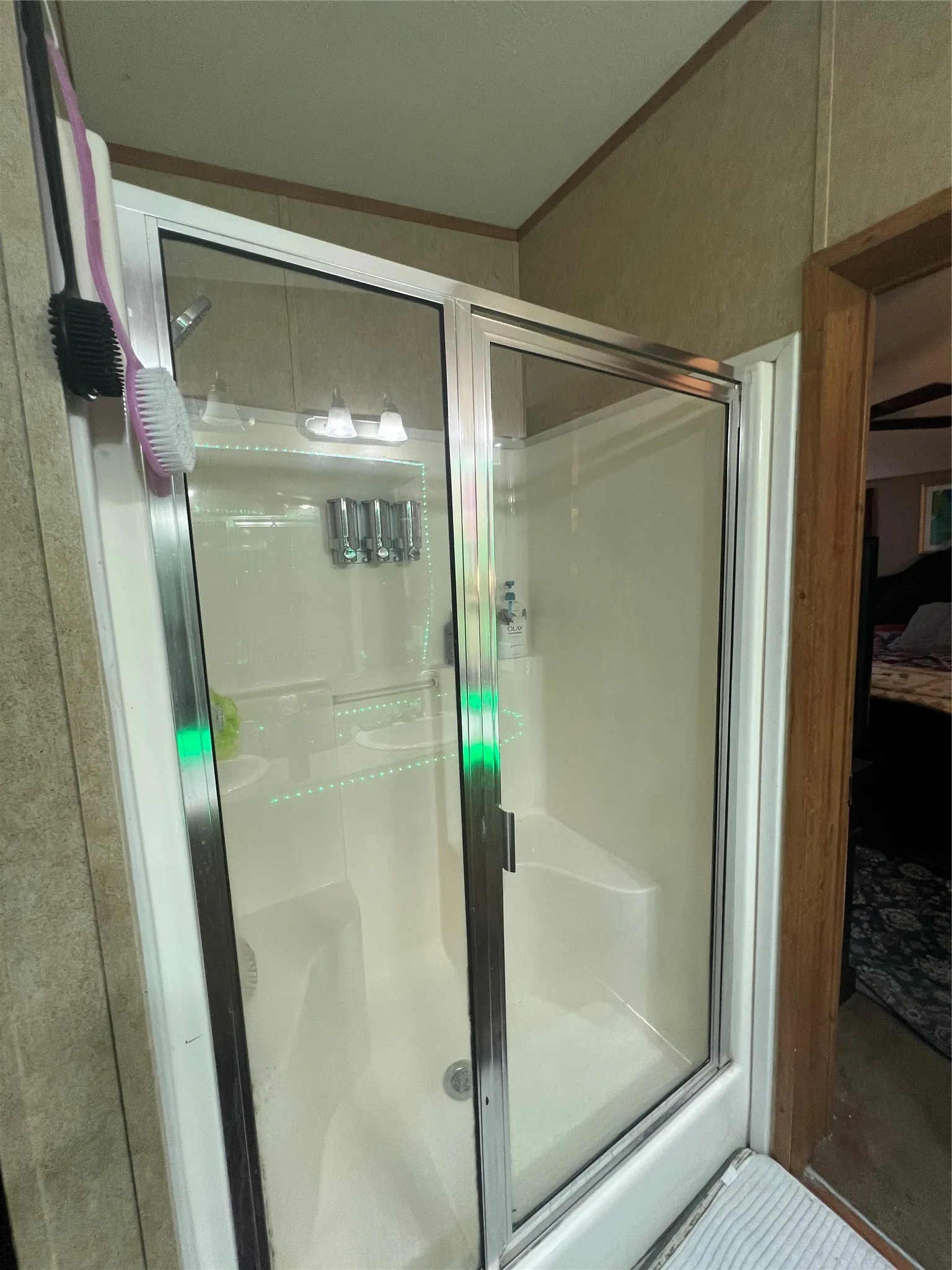 Enclosed shower with clear glass sliding doors and a white base