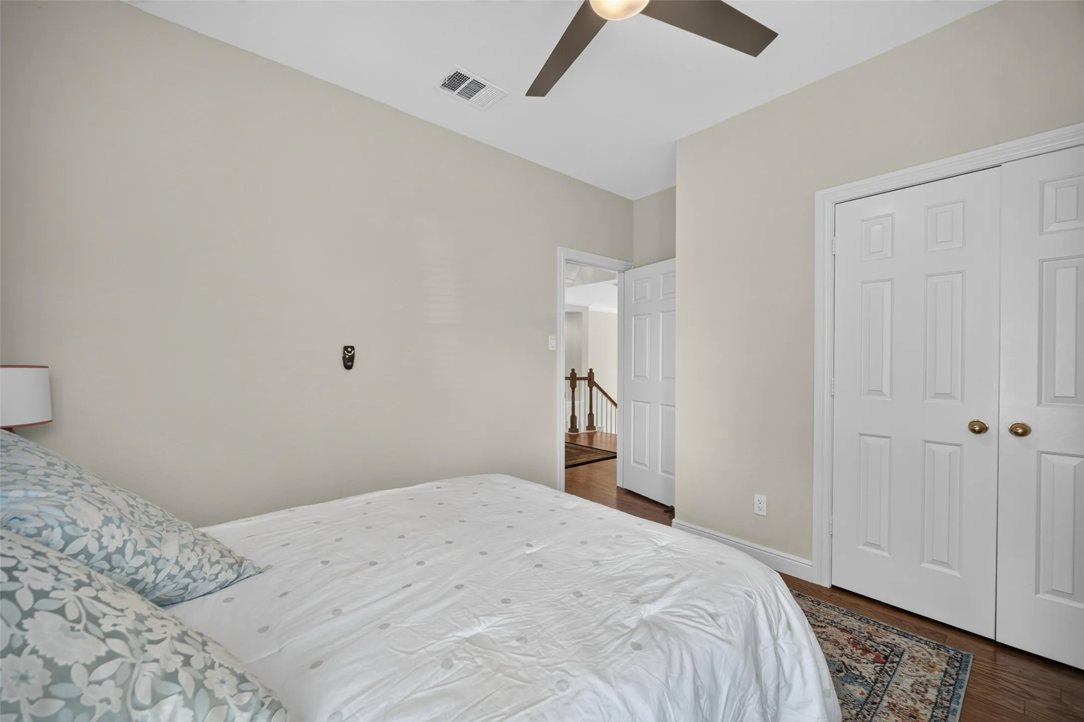 Recessed ceiling fan, wood-finish flooring, paneled bifold closet doors, and light neutral wall paint