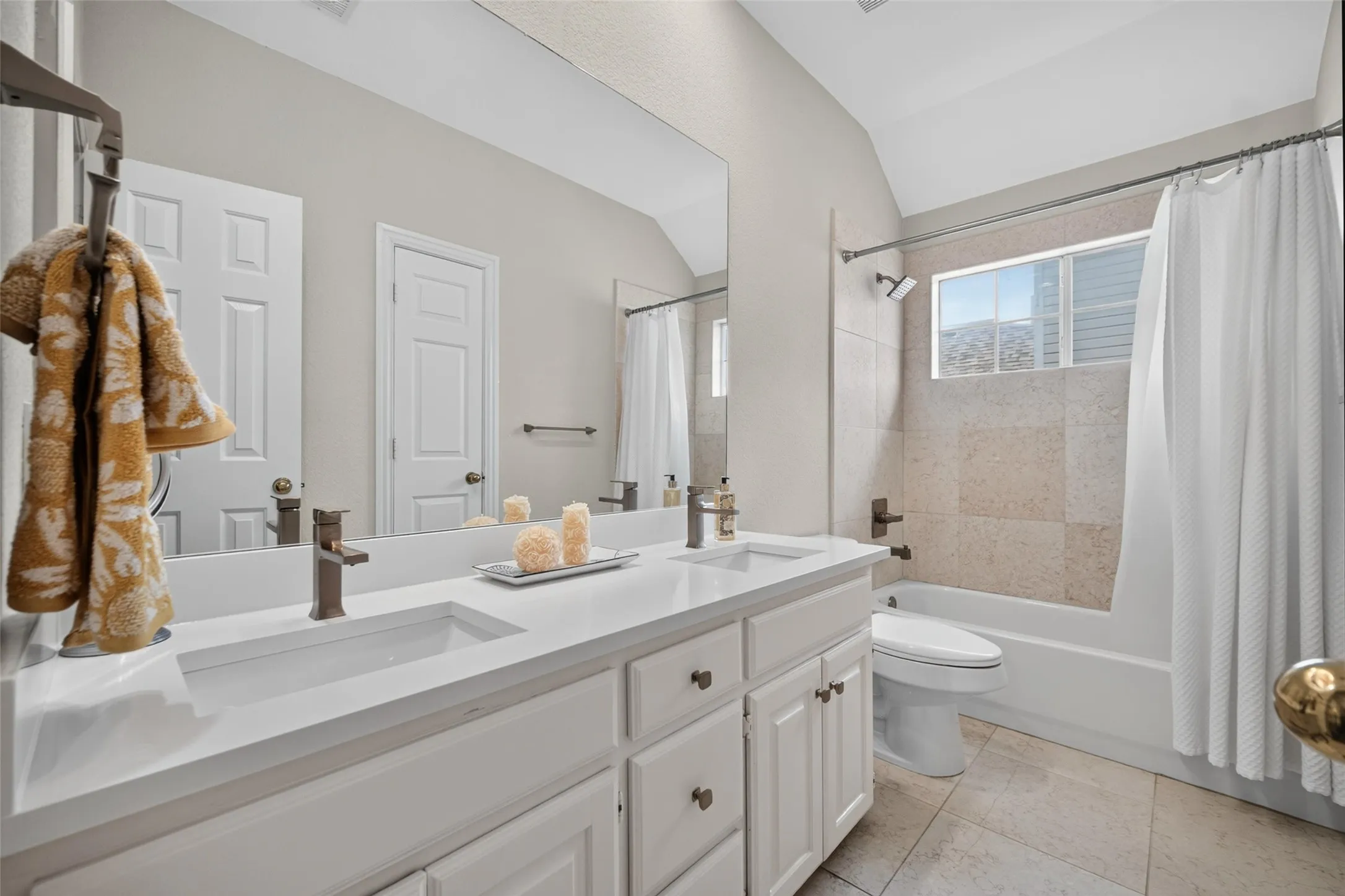 Dual vanity with integrated sinks, white cabinetry, and bronze-finish fixtures