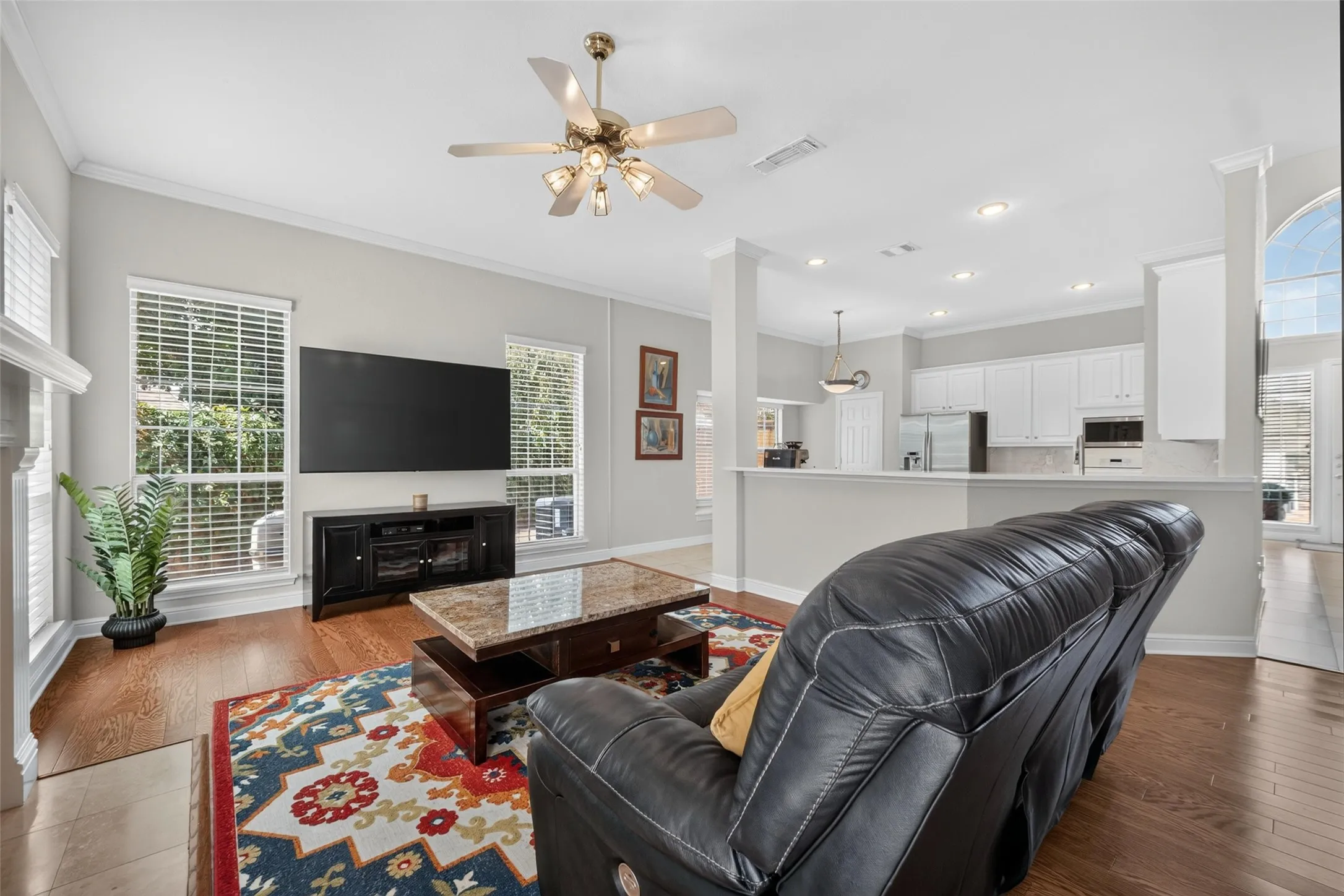 Warm wood-finish flooring complements the light-toned walls