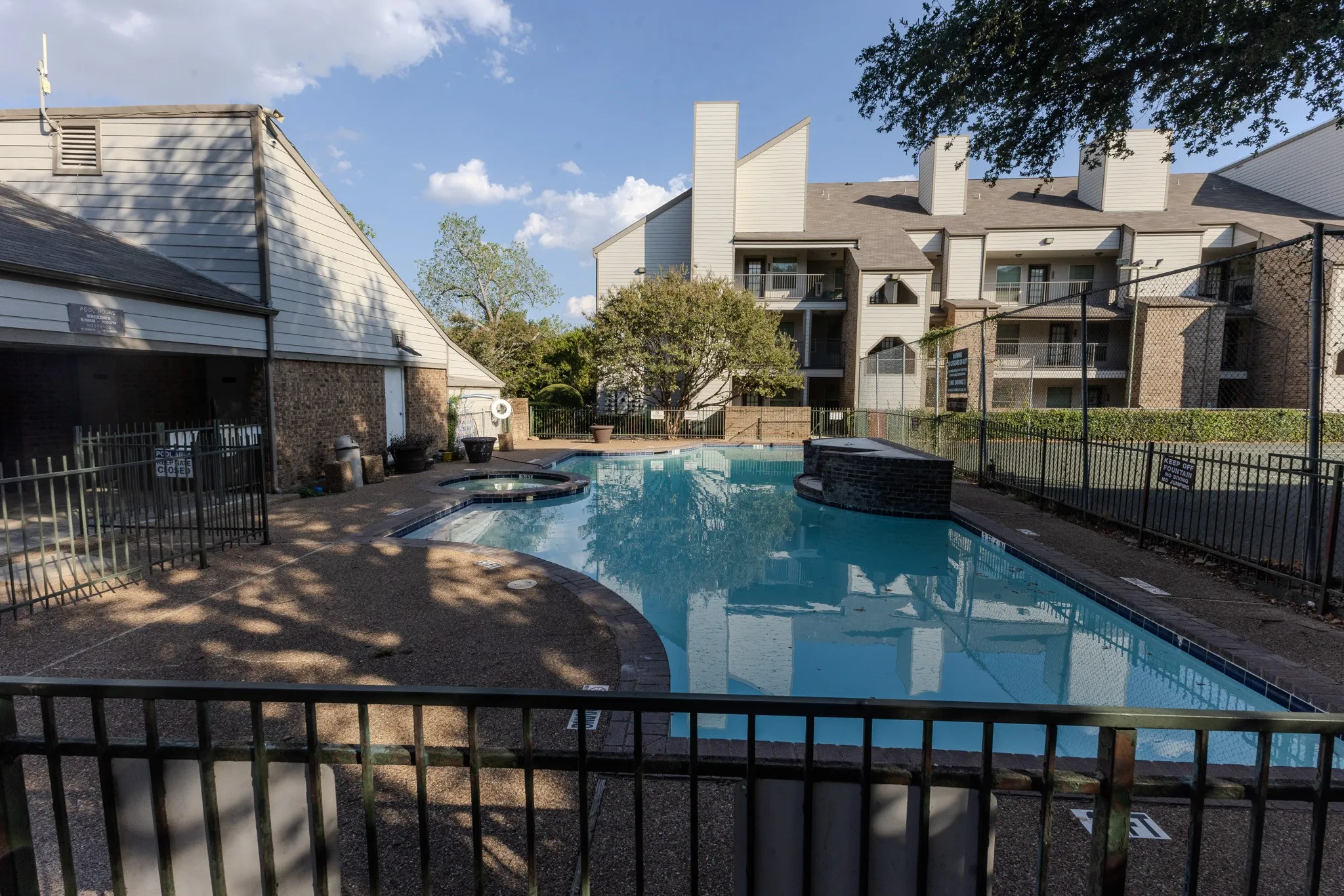 Resort-style pool with integrated spa and surrounding hardscaping
