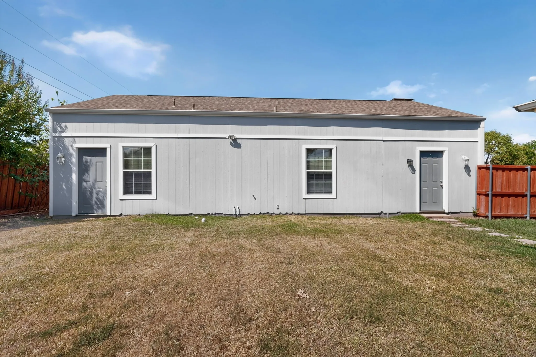 Exterior building with dual entry doors and two windows