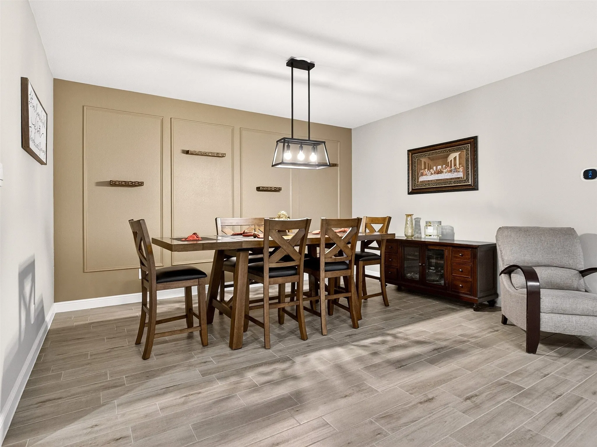 Rectangular wood-finish flooring, recessed lighting, and a contemporary chandelier