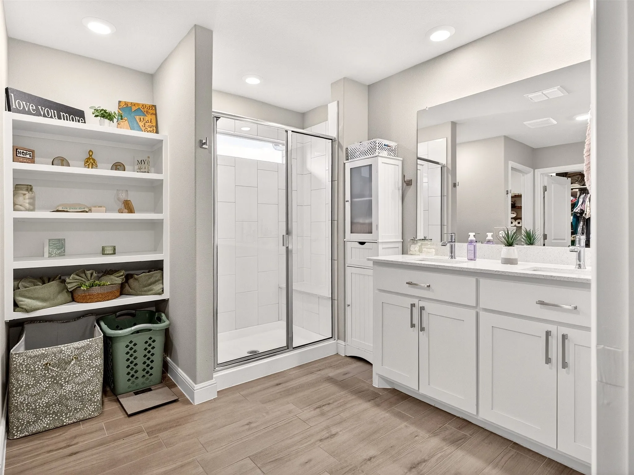 Dual vanity with undermount sinks, white cabinetry, and brushed nickel hardware