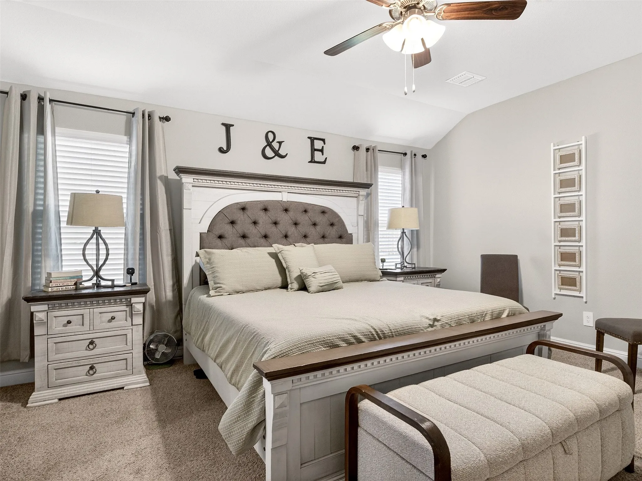 Vaulted ceiling with a ceiling fan, carpet flooring, window with blinds and curtains, and light gray wall paint