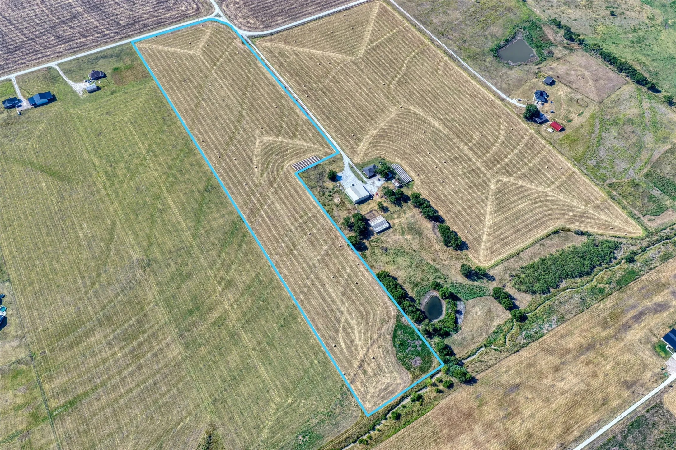 Aerial Photography. Showing the property with its boundaries outlined, comprising agricultural land and structures