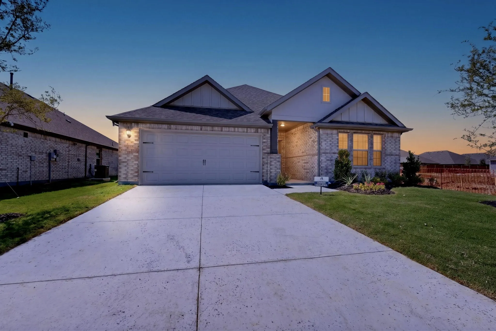Brick and siding exterior with a two-car garage