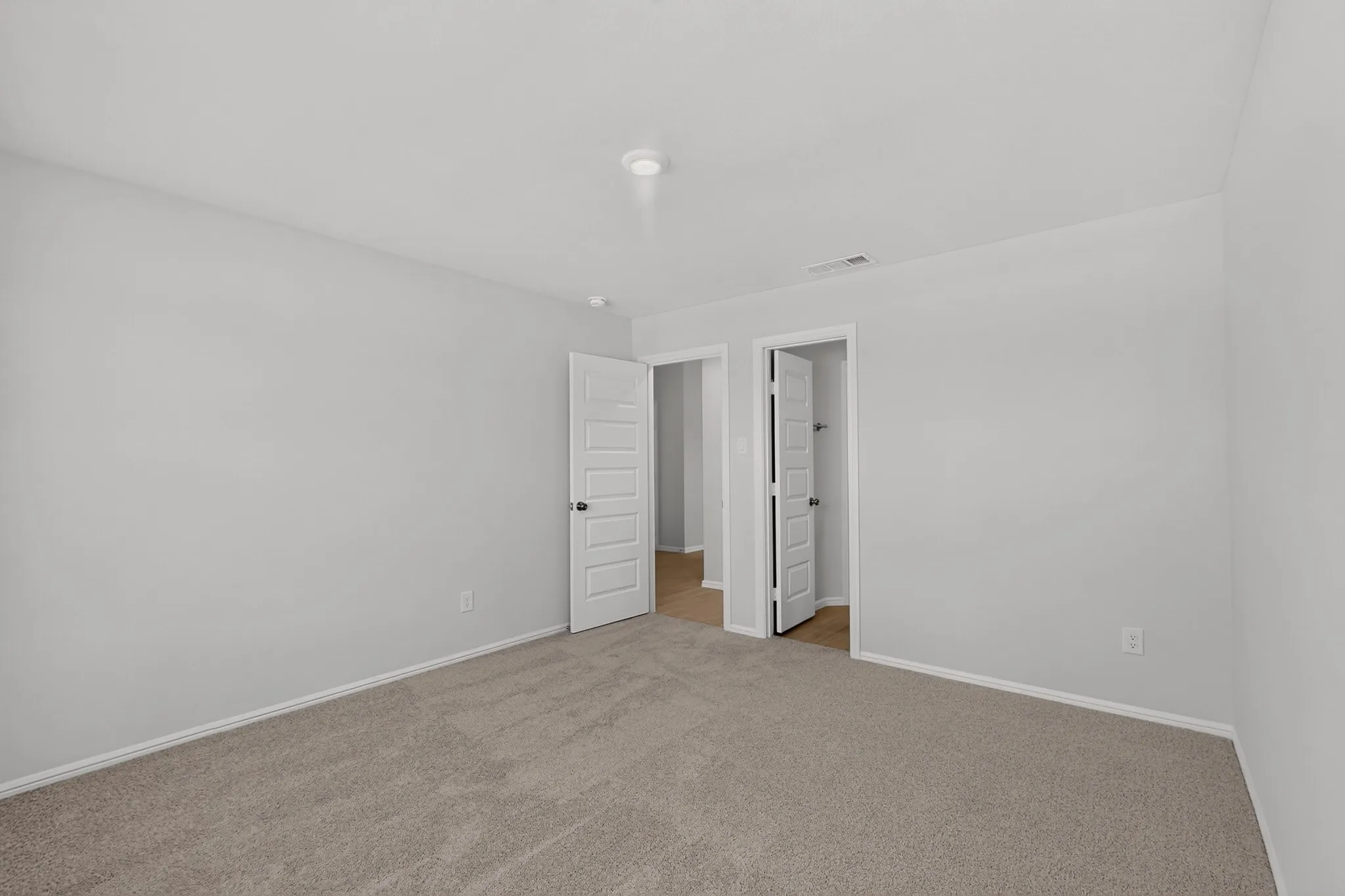 Plush carpeting and light gray wall paint