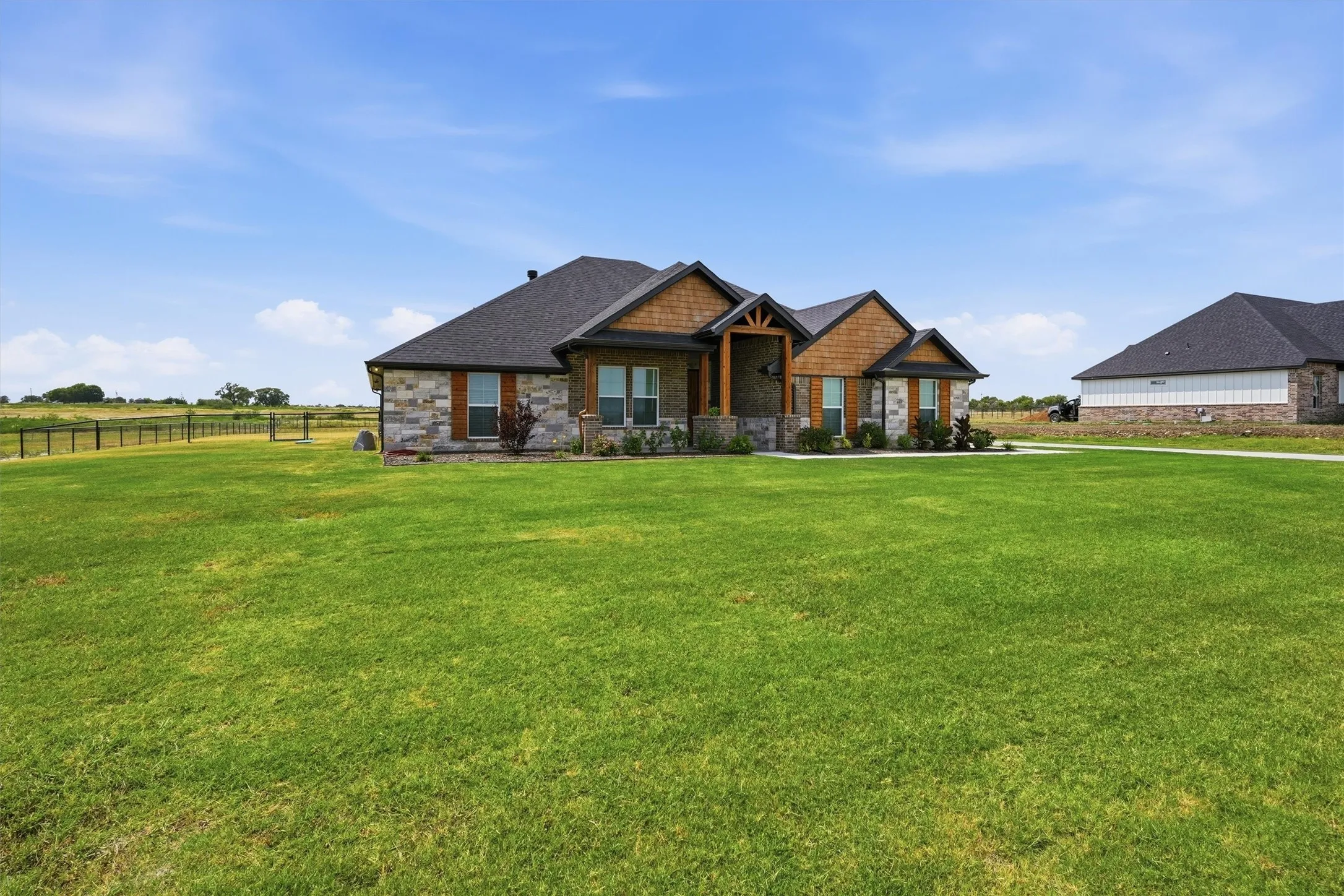 Stone and wood-finish exterior with dark roofing