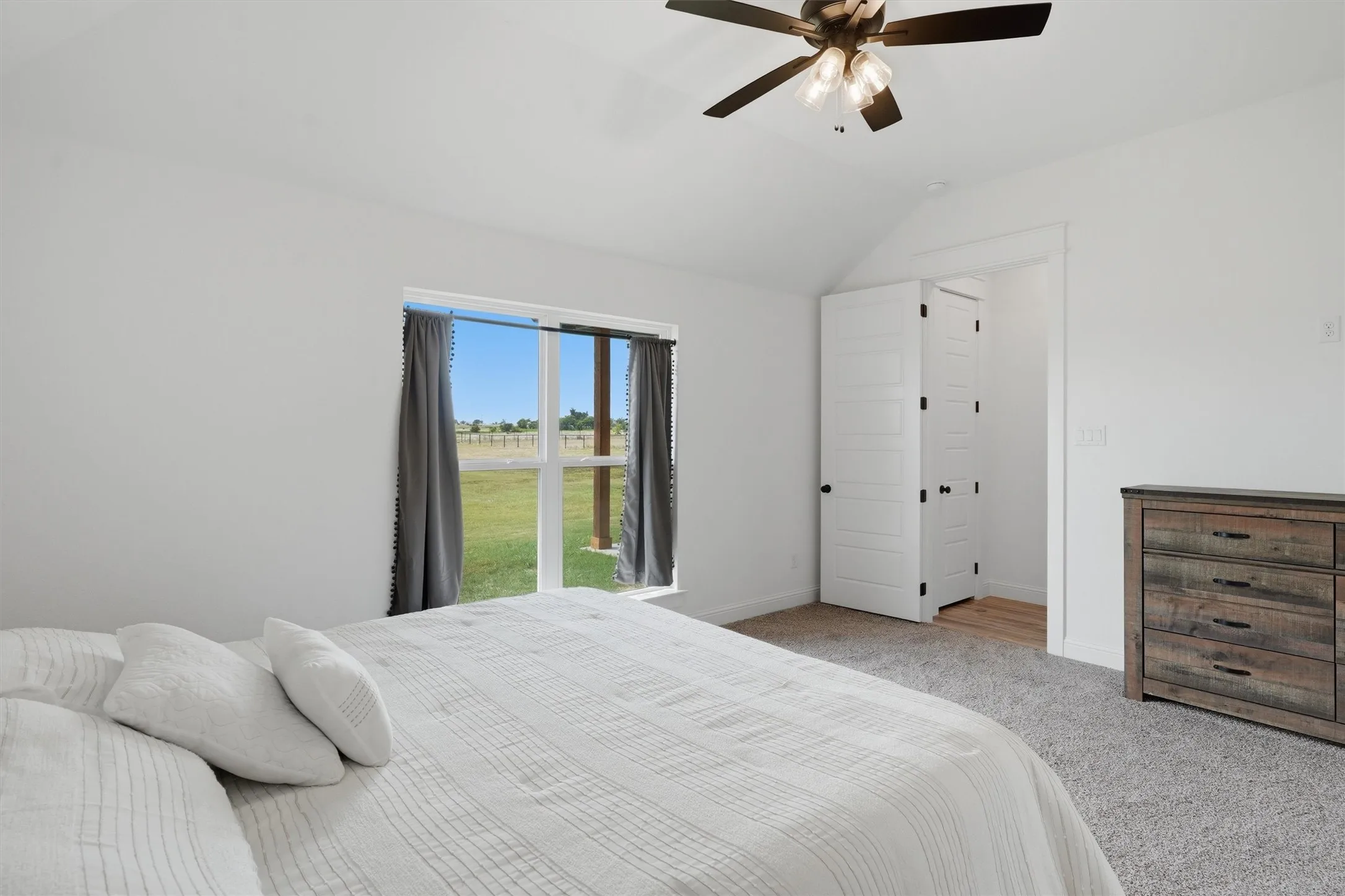 Vaulted ceiling featuring a ceiling fan with integrated lighting