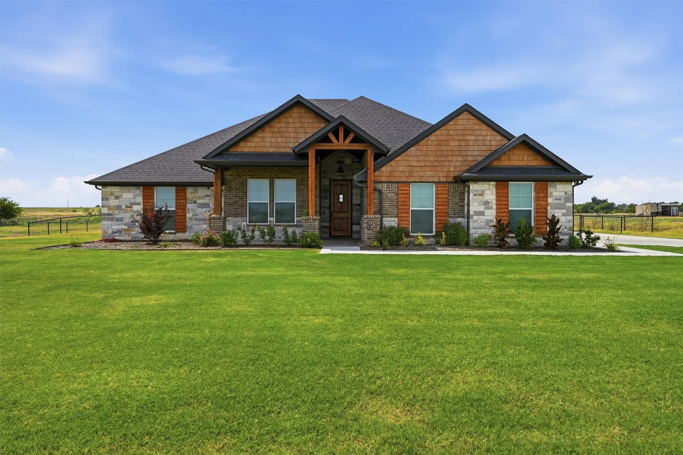 Stone and wood shake exterior with dark trim accents