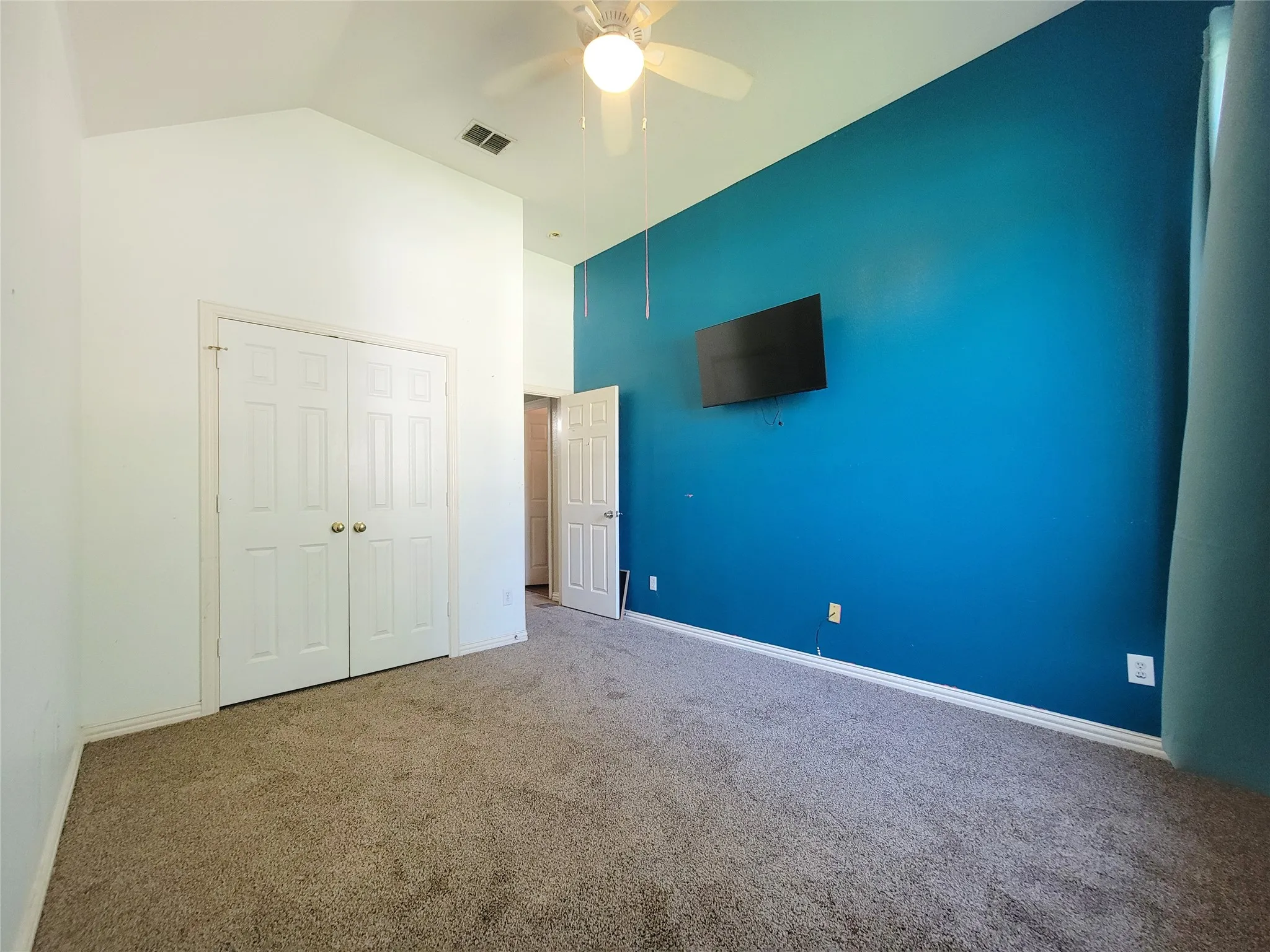Brand new Carpet, Vaulted ceiling with an attached ceiling fan, carpeted flooring, and a closet with bifold doors