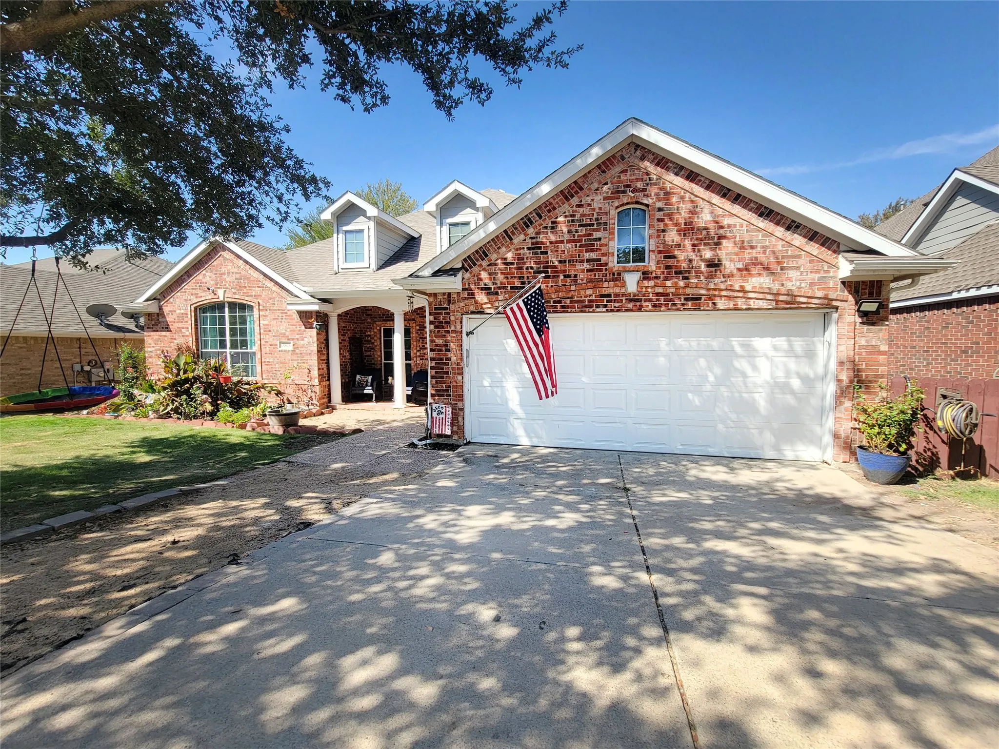 Brick exterior with an arched entryway and dormer windows