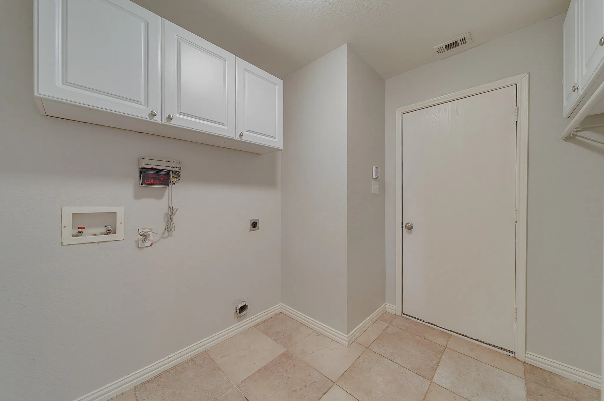 White shaker-style cabinetry with silver-tone hardware, providing storage