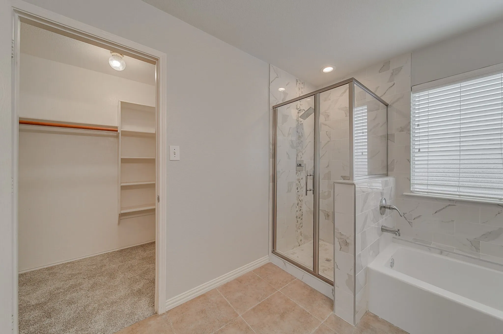 Walk-in closet with built-in shelving and carpet flooring