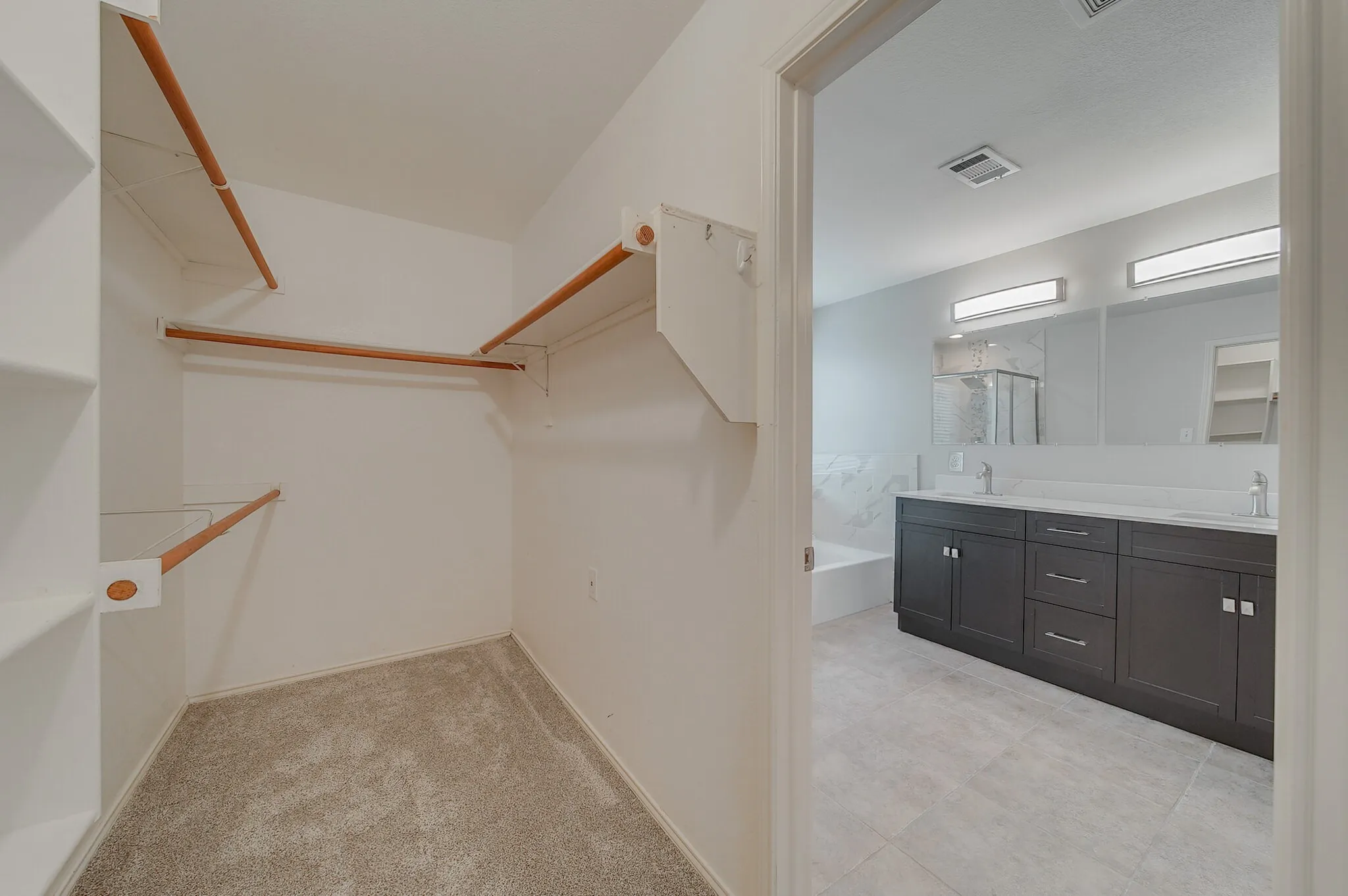 Walk-in closet with built-in shelving and hanging rods