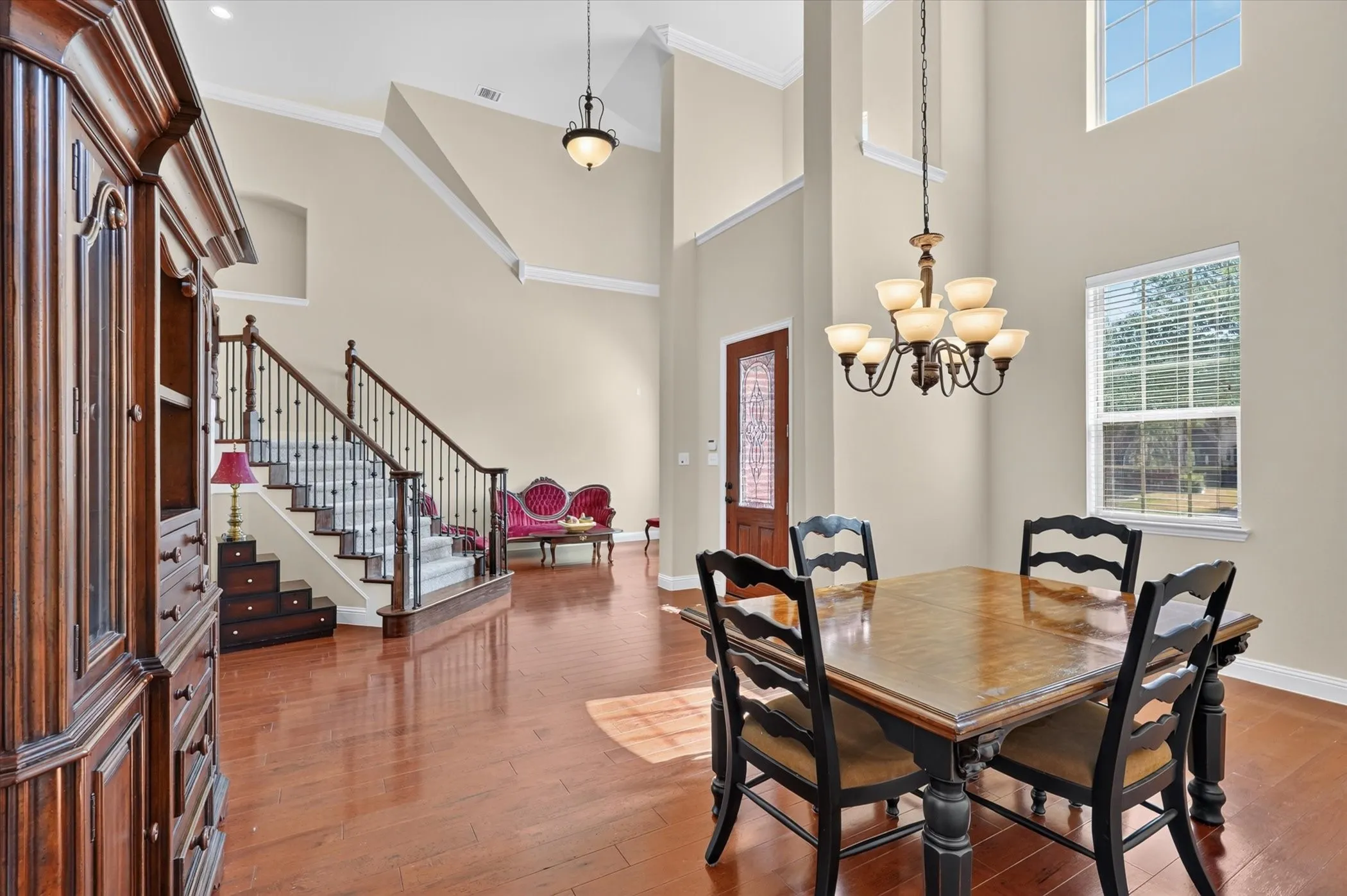 The formal spaces in this home are flooded with light from the expansive multi-tier windows.