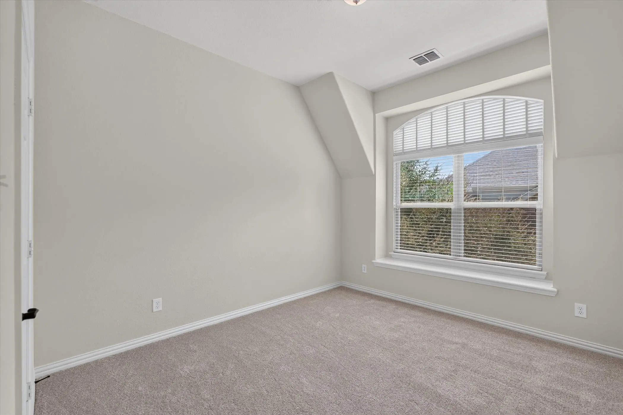 Pretty views of the woods (and lake in the winter) from this bedroom.