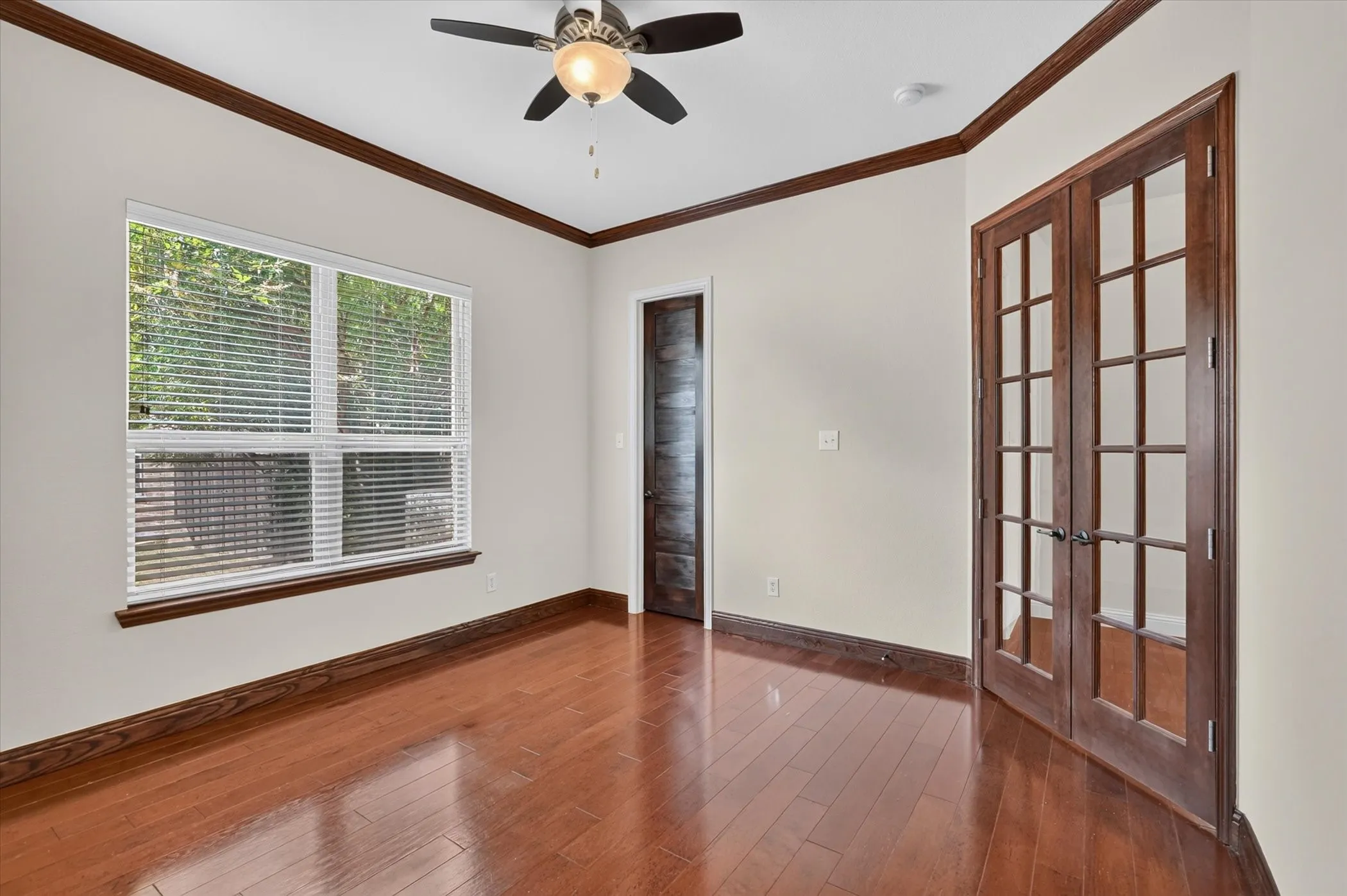 The study has elegant wooden french doors and an upgraded solid wood door leading into a walk in closet.