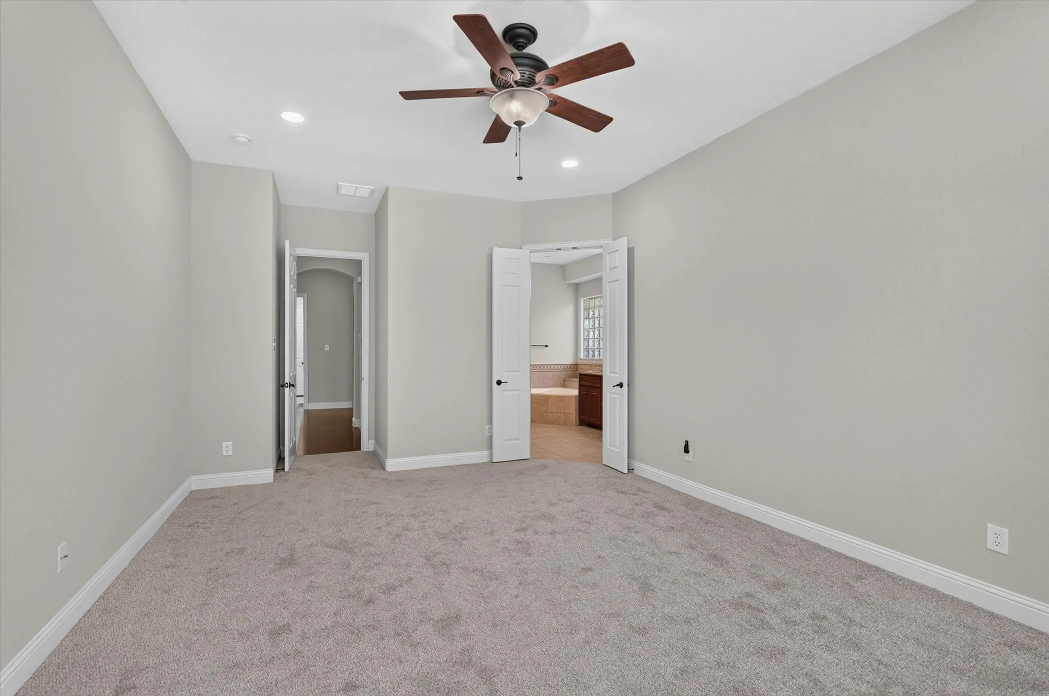 Primary bedroom sits down a hall for maximum privacy.