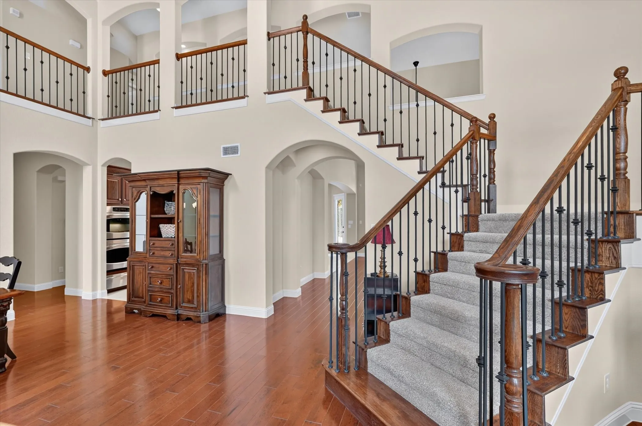 A seemingly endless sweep of custom iron balusters defines thsi grand central foyer and staircase.