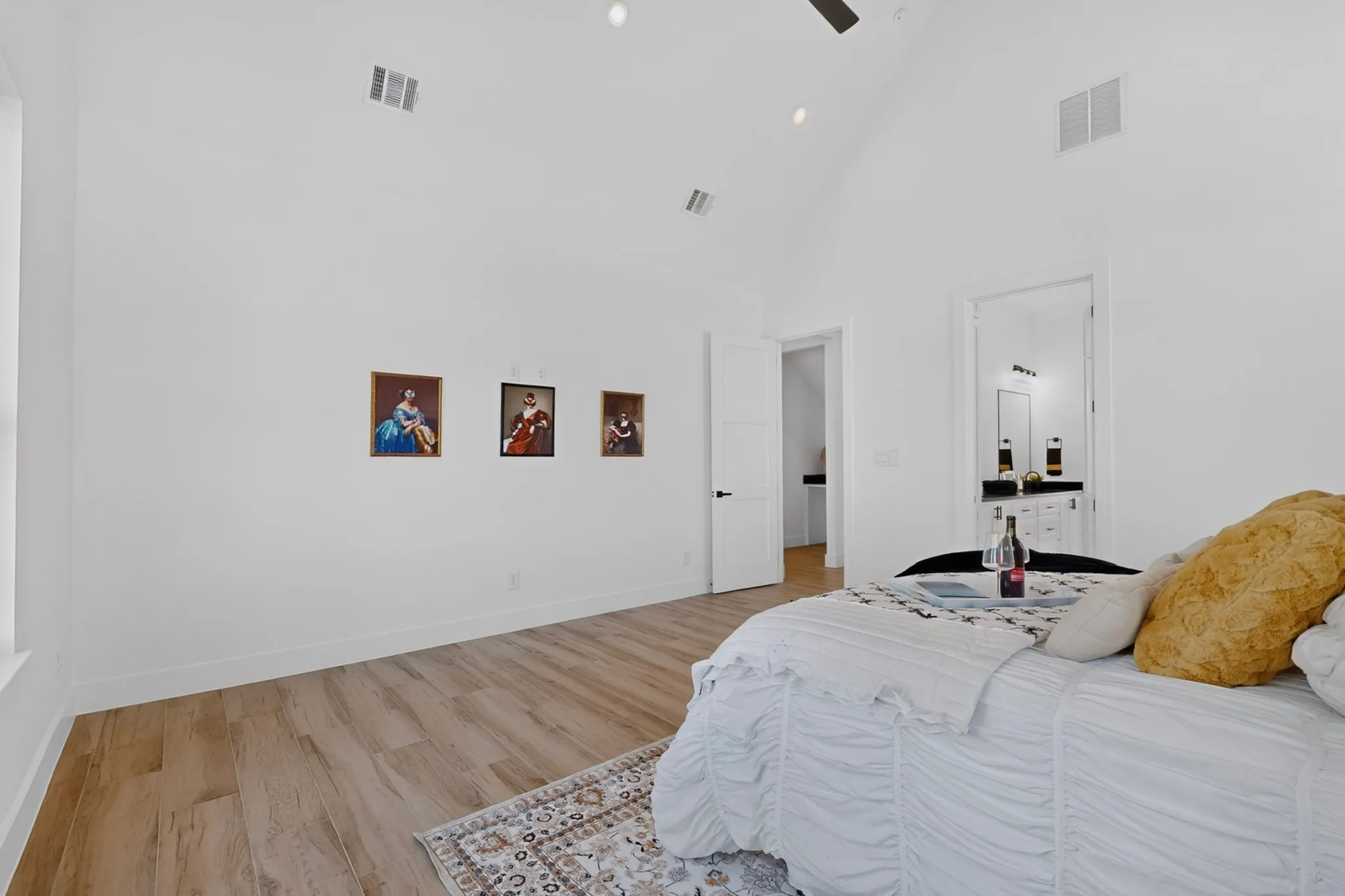 Vaulted ceiling with recessed lighting and a ceiling fan, wood-finish flooring, and white interior doors