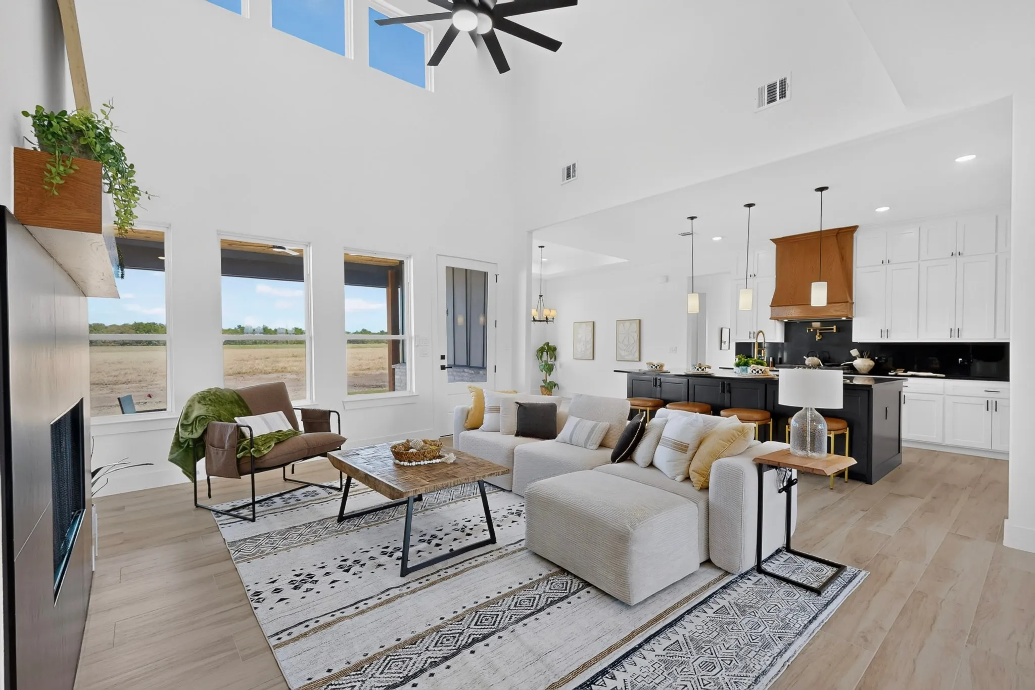 Vaulted ceiling with a ceiling fan, recessed lighting, and upper transom windows