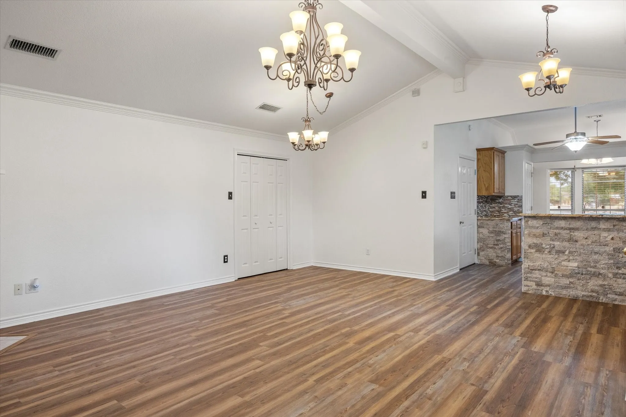 Living room with luxury vinyl plank flooring and decorative lighting
