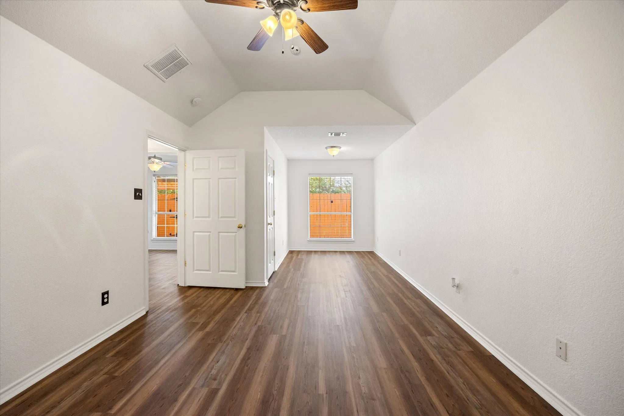 Primary bedroom with ceiling fan, secondary closet and sitting area