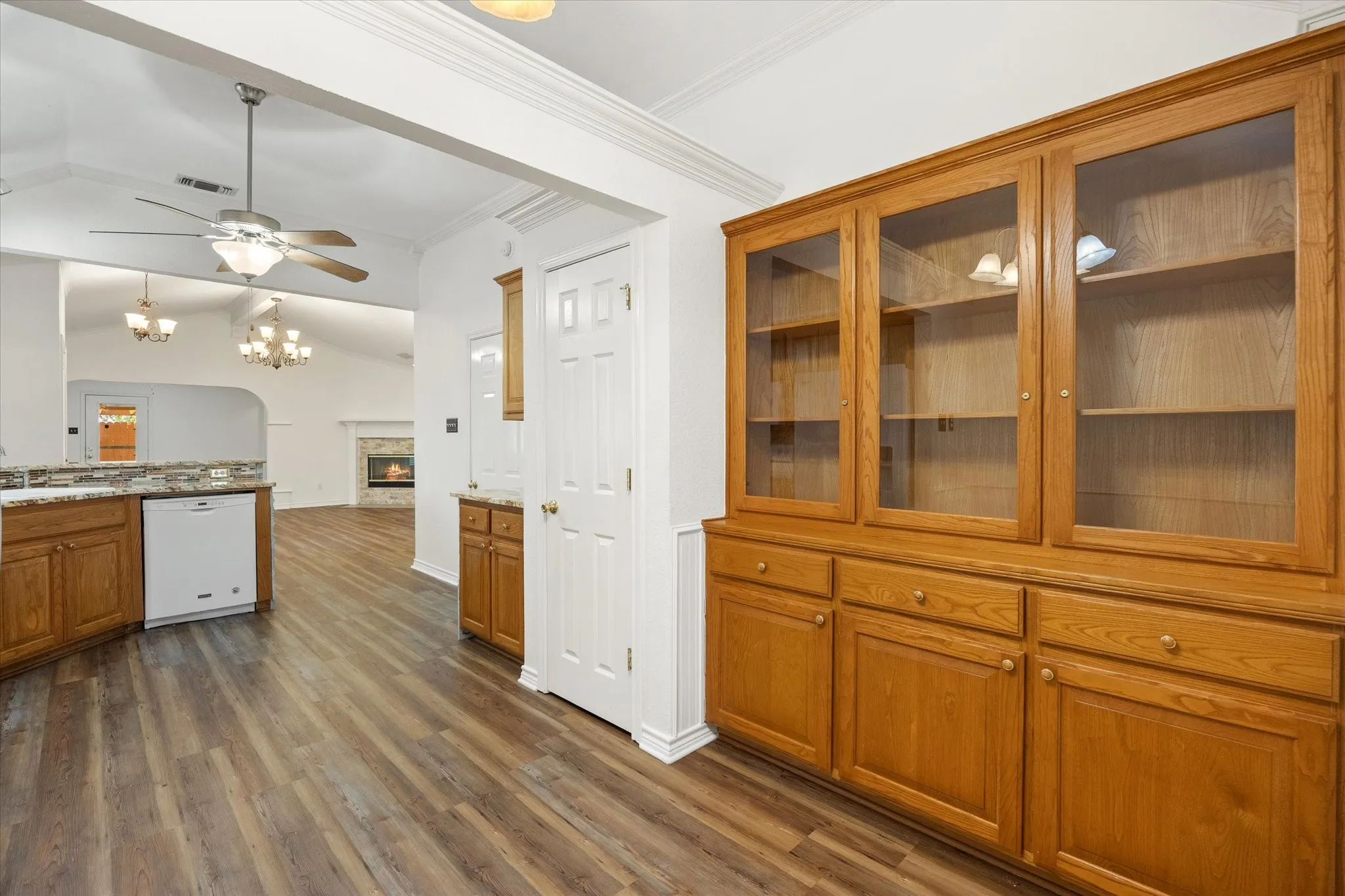 Built-in cabinets with glass doors, luxury vinyl plank flooring