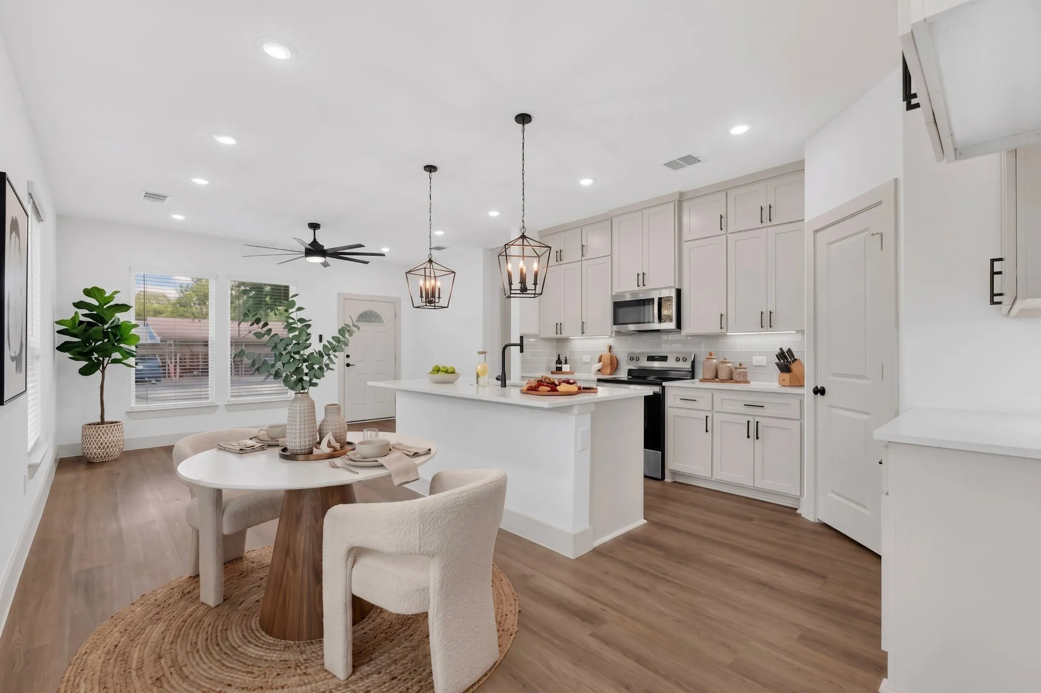 (Virtual Staging)Open -concept living area with wood-finish flooring, recessed lighting, and a ceiling fan