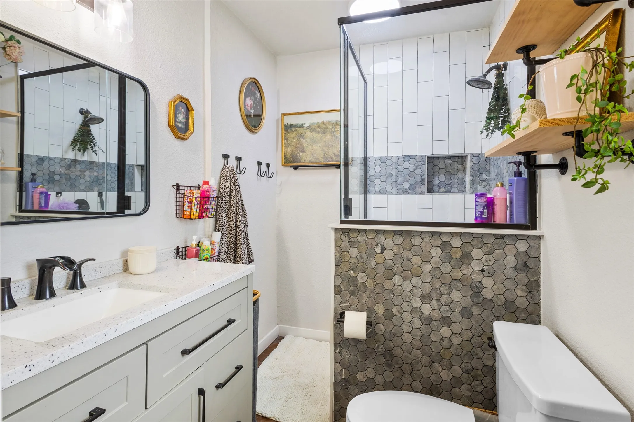 Vanity with a speckled countertop and matte black fixtures