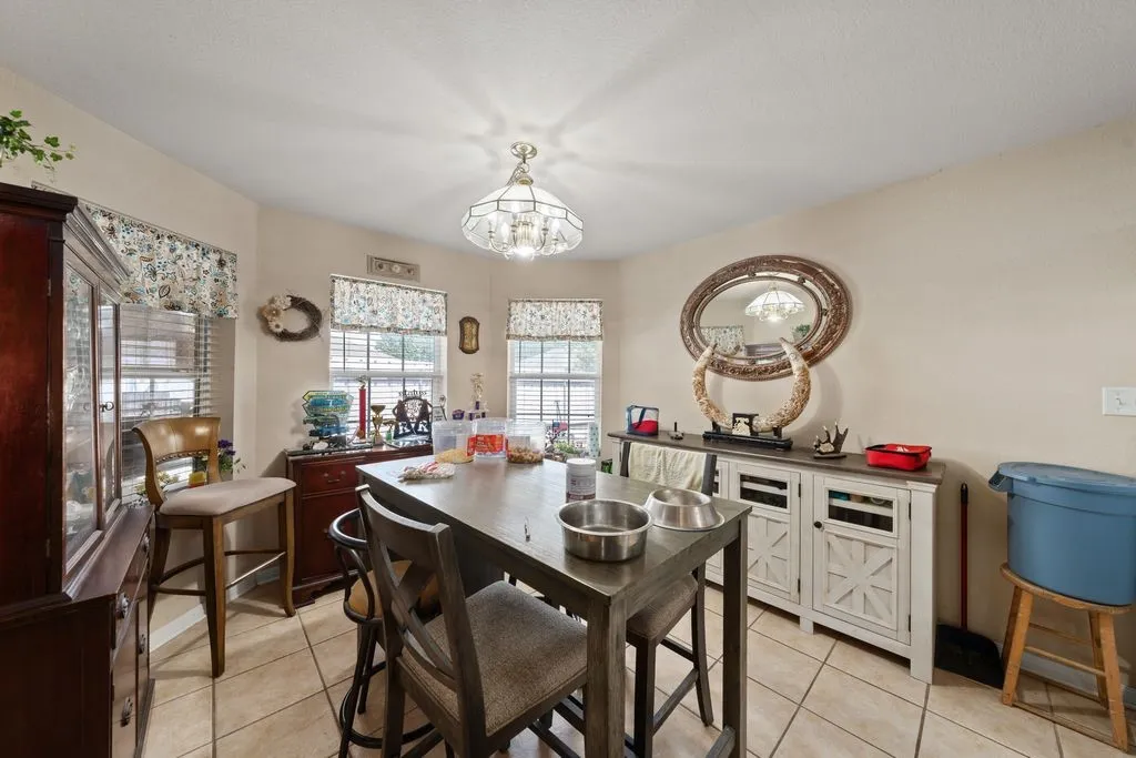 Recessed lighting and tile flooring complement the neutral wall tones