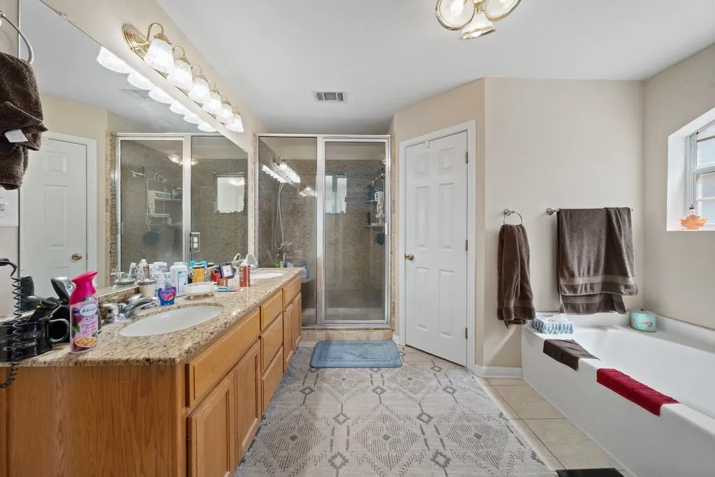 Dual vanity with light-tone countertops and under-mount sinks