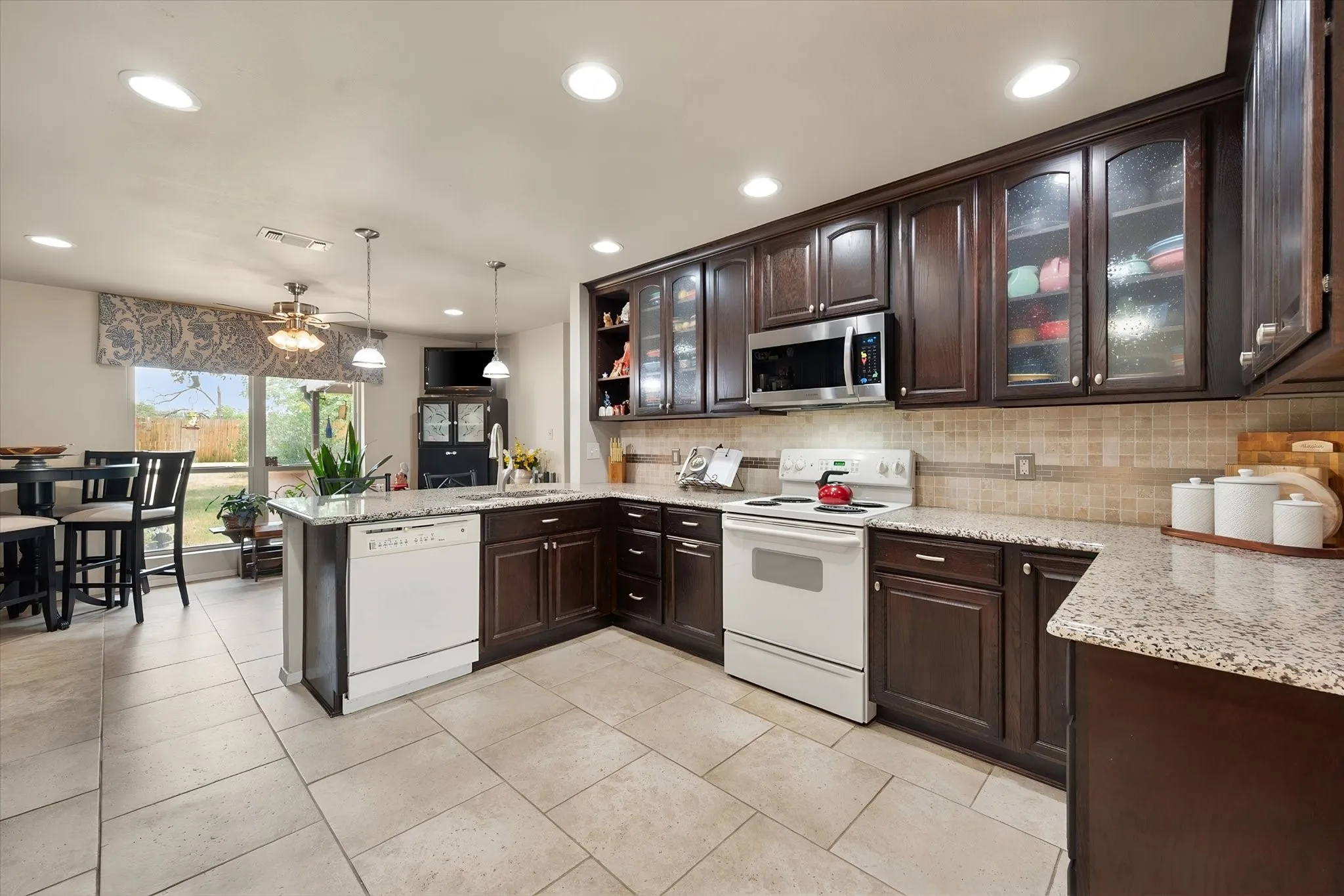 Updates include smooth ceilings, custom cabinets with glass doors and granite countertops.