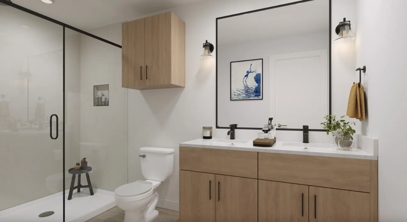 Full bath featuring a shower stall and double vanity
