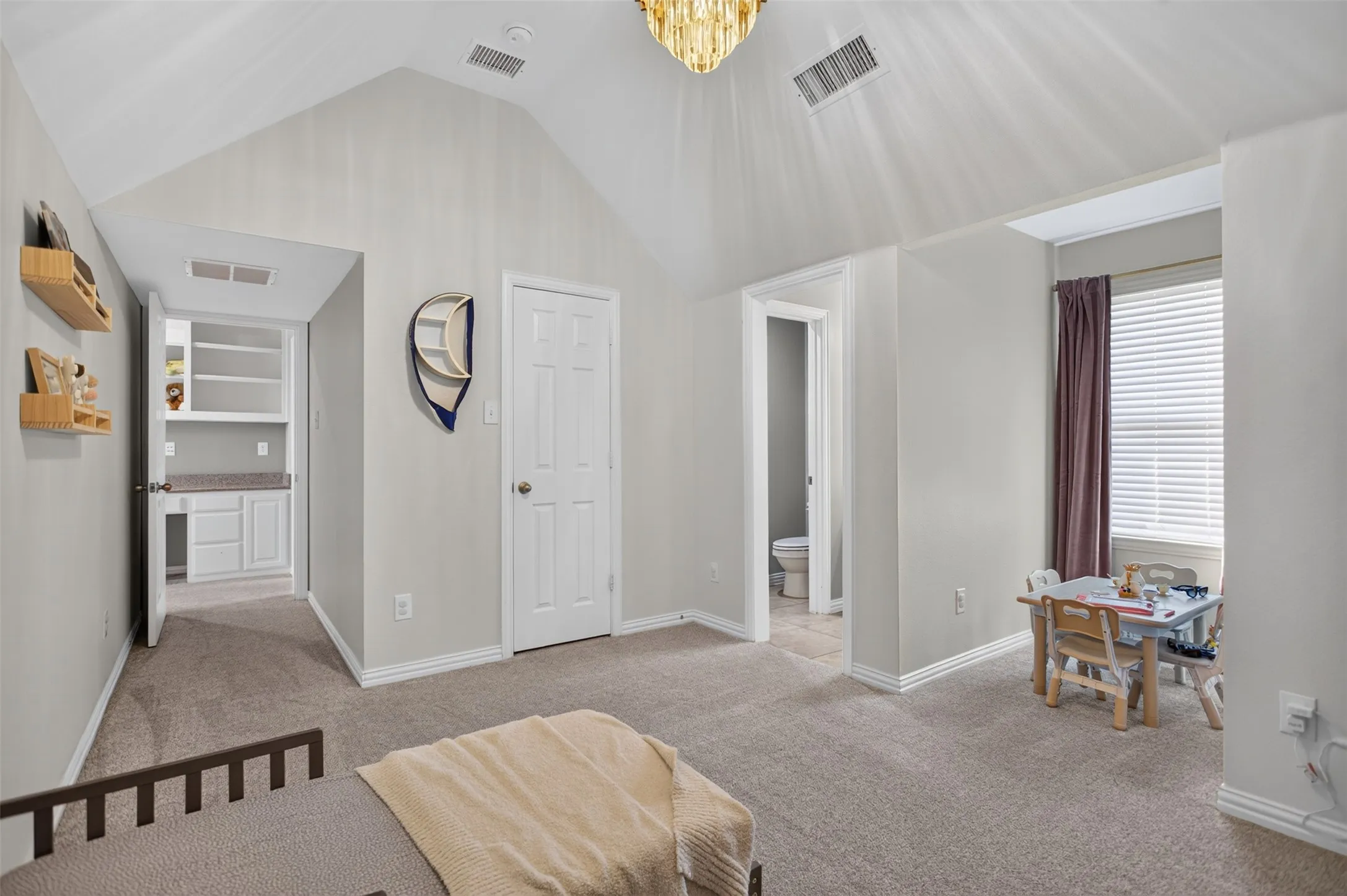 Vaulted ceiling room featuring carpet flooring, natural light from a window with blinds, and white trim throughout