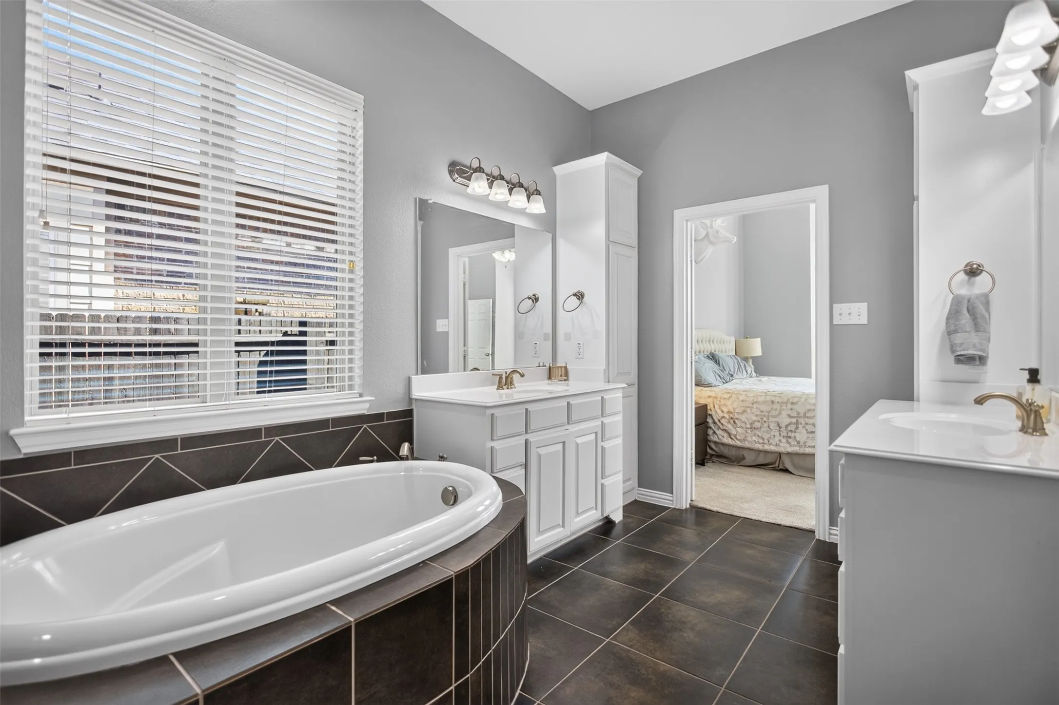 Soaking tub with dark tile surround