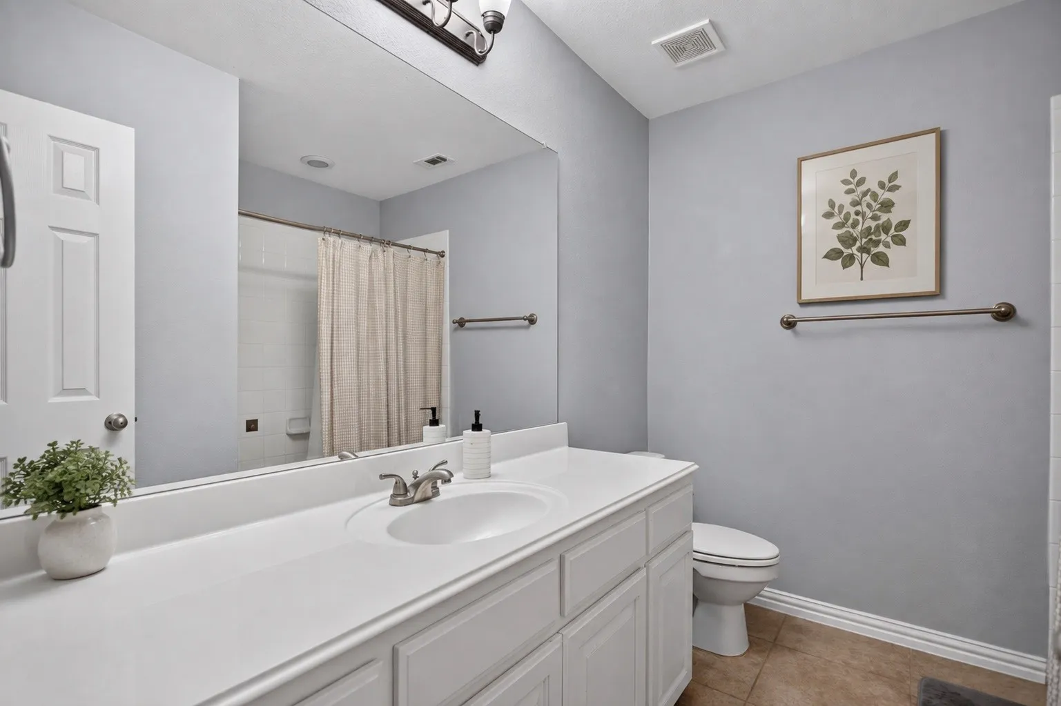Vanity with integrated sink, white cabinetry, and brushed nickel faucet