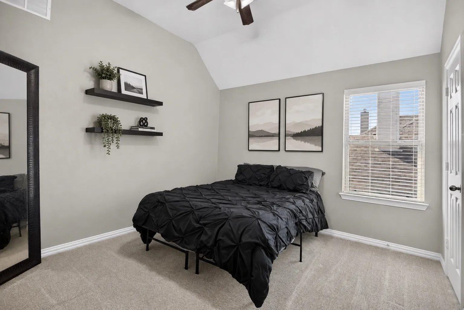 Vaulted ceiling with a ceiling fan, light gray wall paint, carpeted flooring, and a single window with blinds