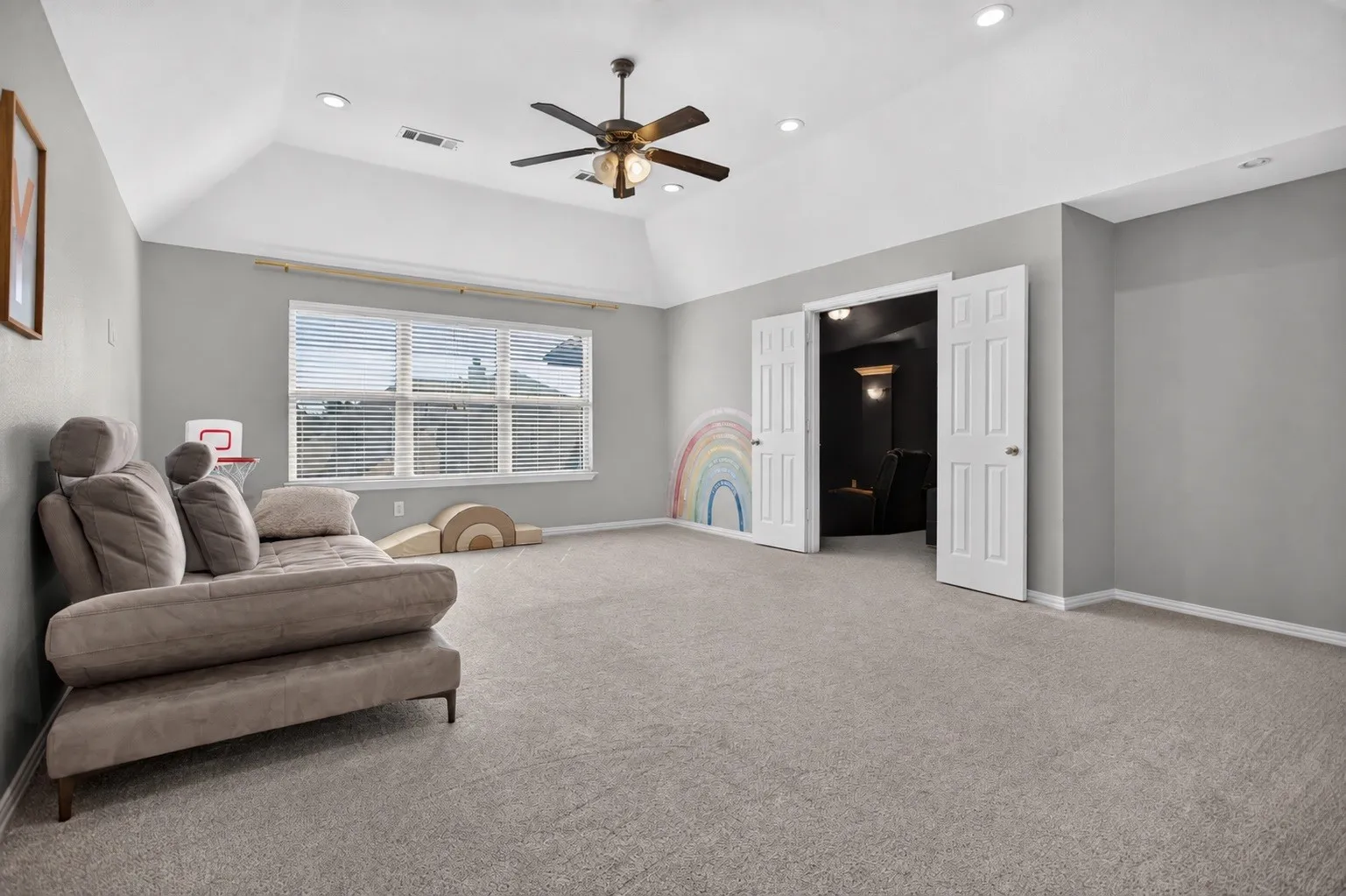 Vaulted ceiling with recessed lighting, ceiling fan, carpet flooring, and a window with horizontal blinds