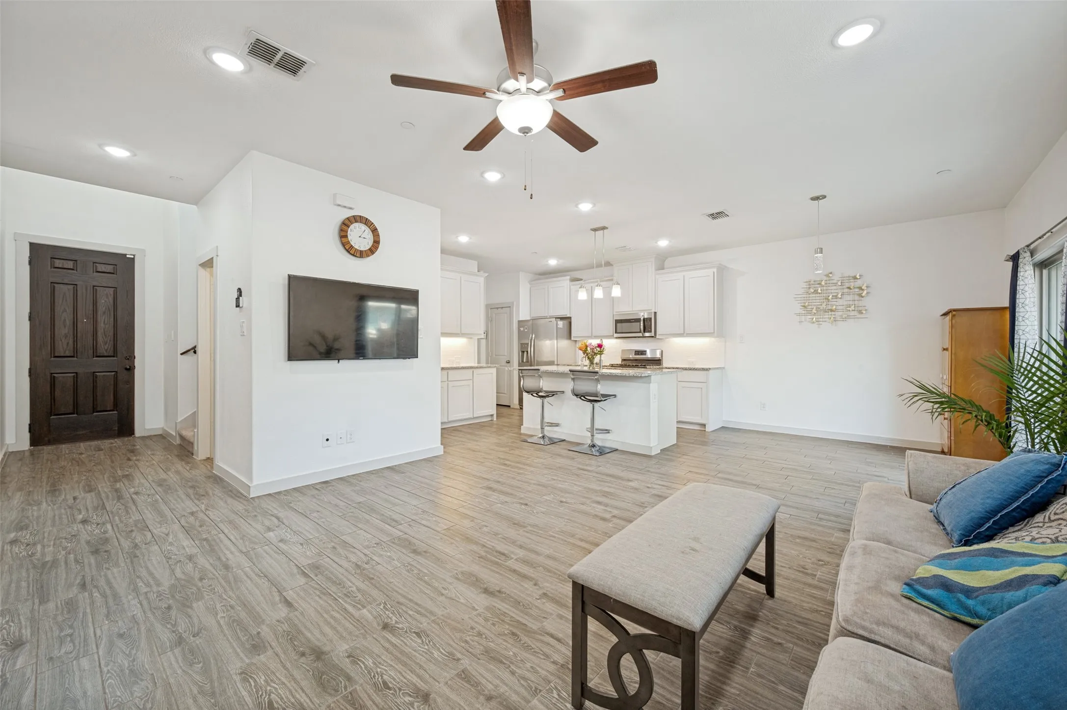 Large ceiling fan to comfortably cool the open concept living area on first level of home.