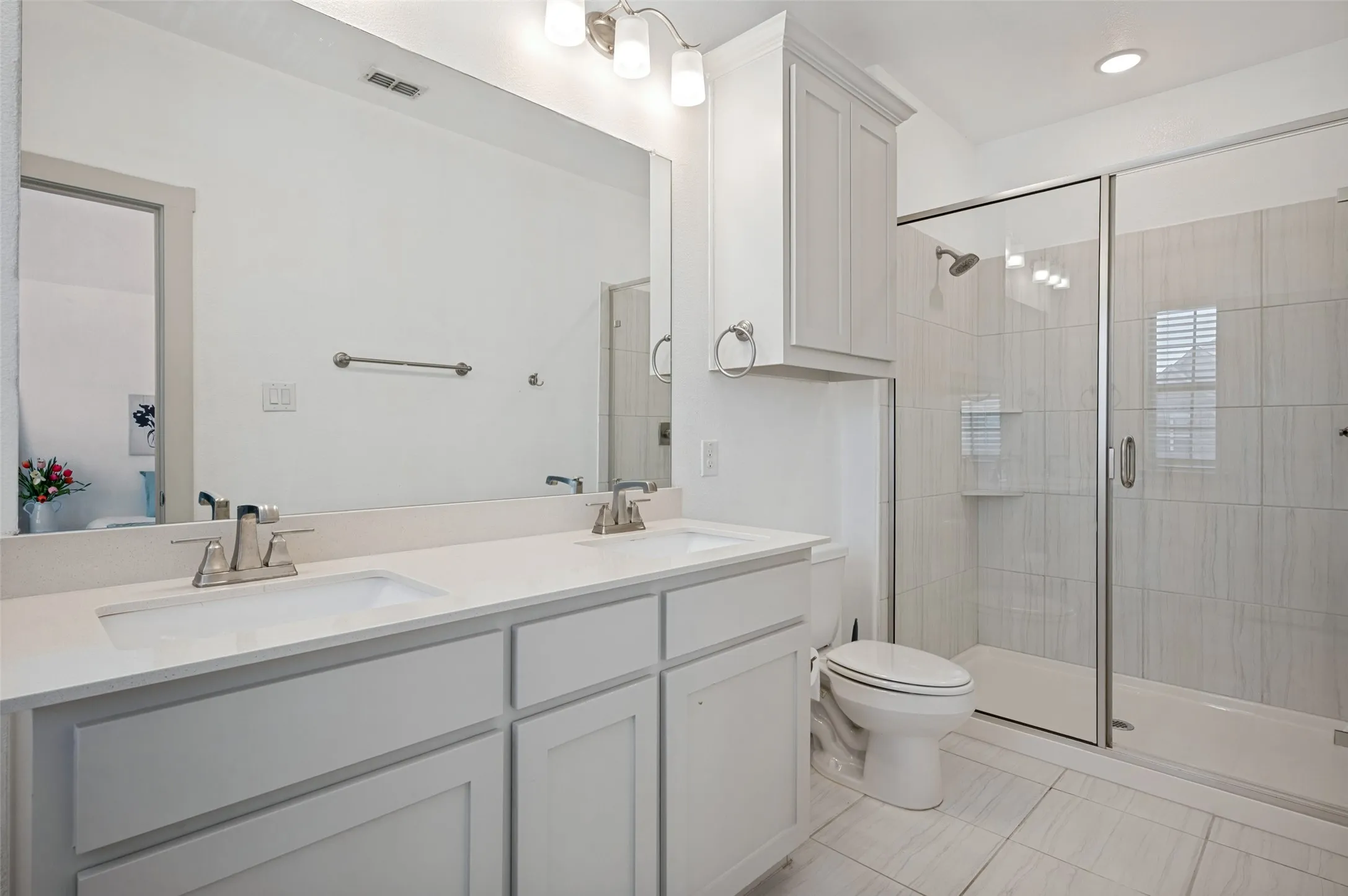 Extra Large walk in shower and double vanity sinks in primary ensuite bathroom.