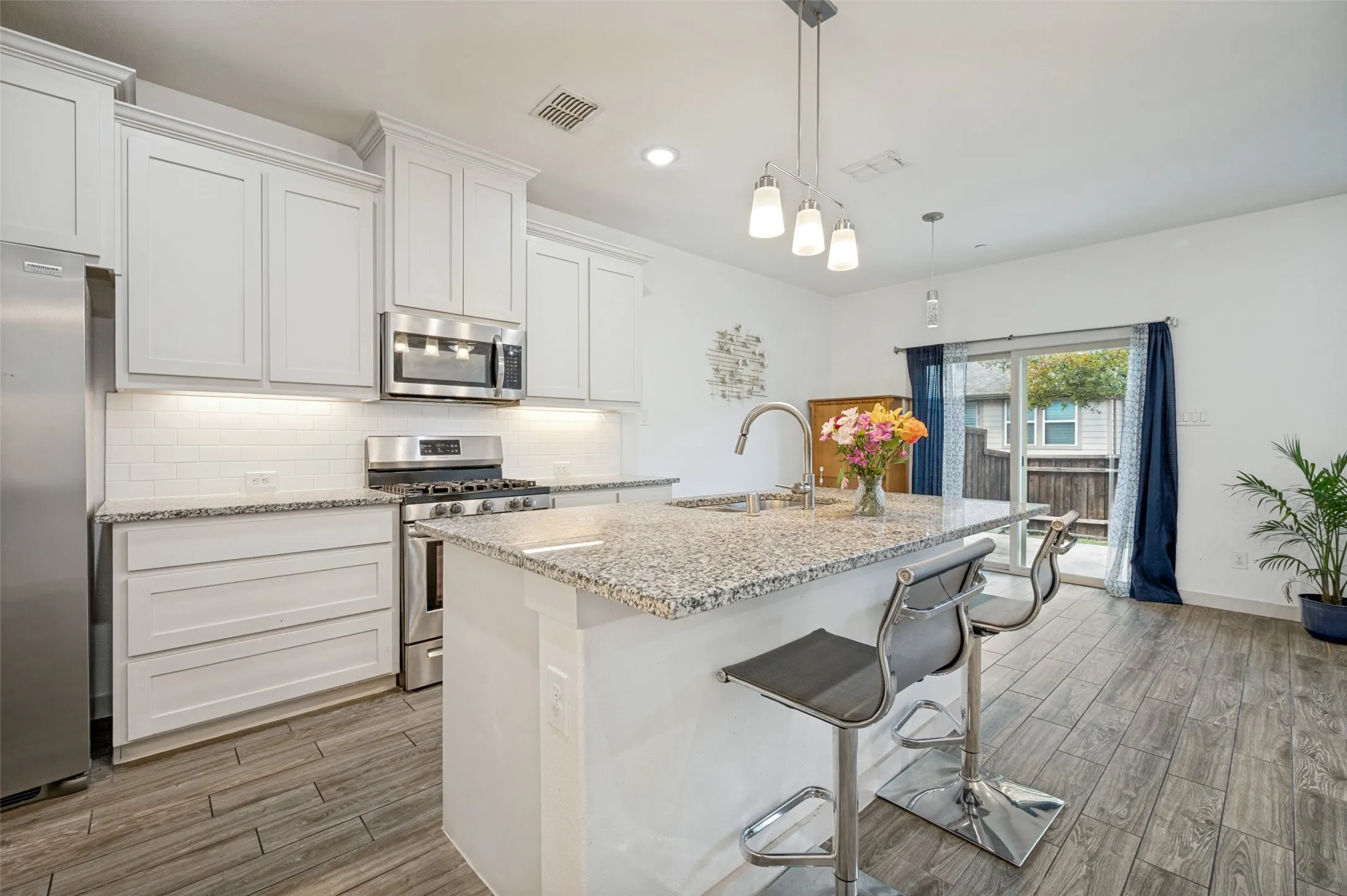 Large granite island for entertaining and dining.