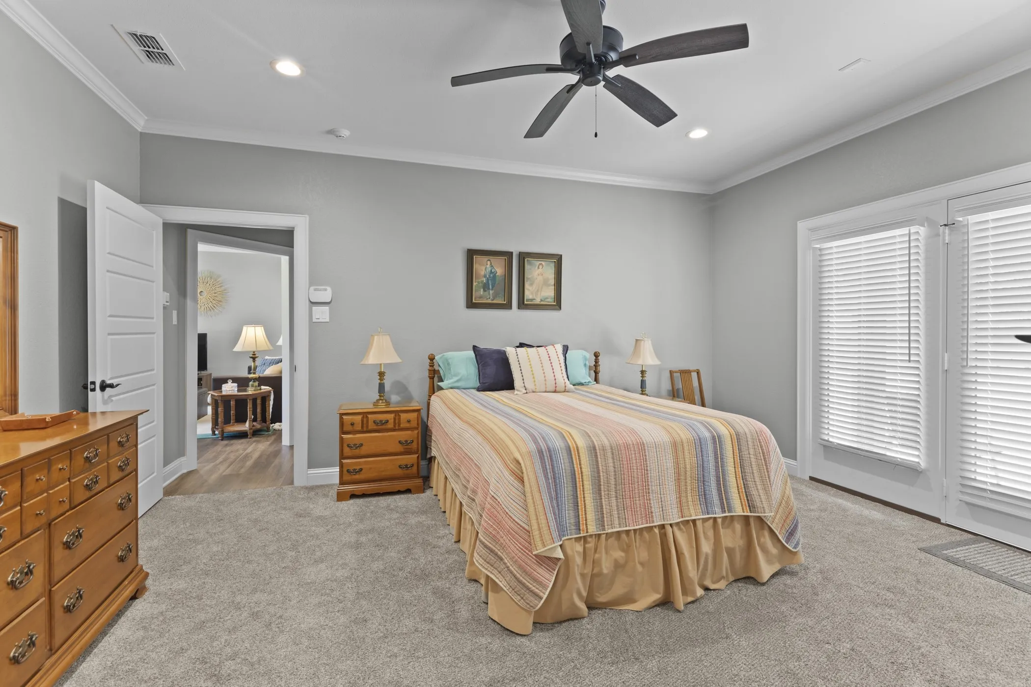 Light gray wall paint, crown molding, ceiling fan with light, recessed lighting, and white door trim