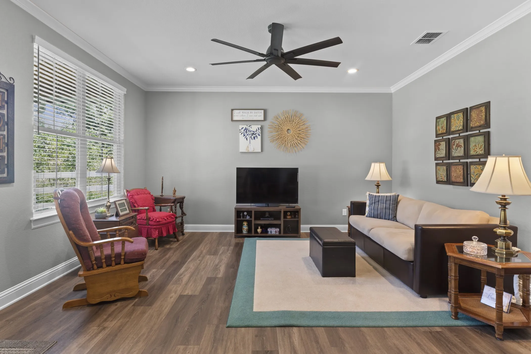 Wood-finish flooring throughout, complemented by a ceiling fan with integrated lighting