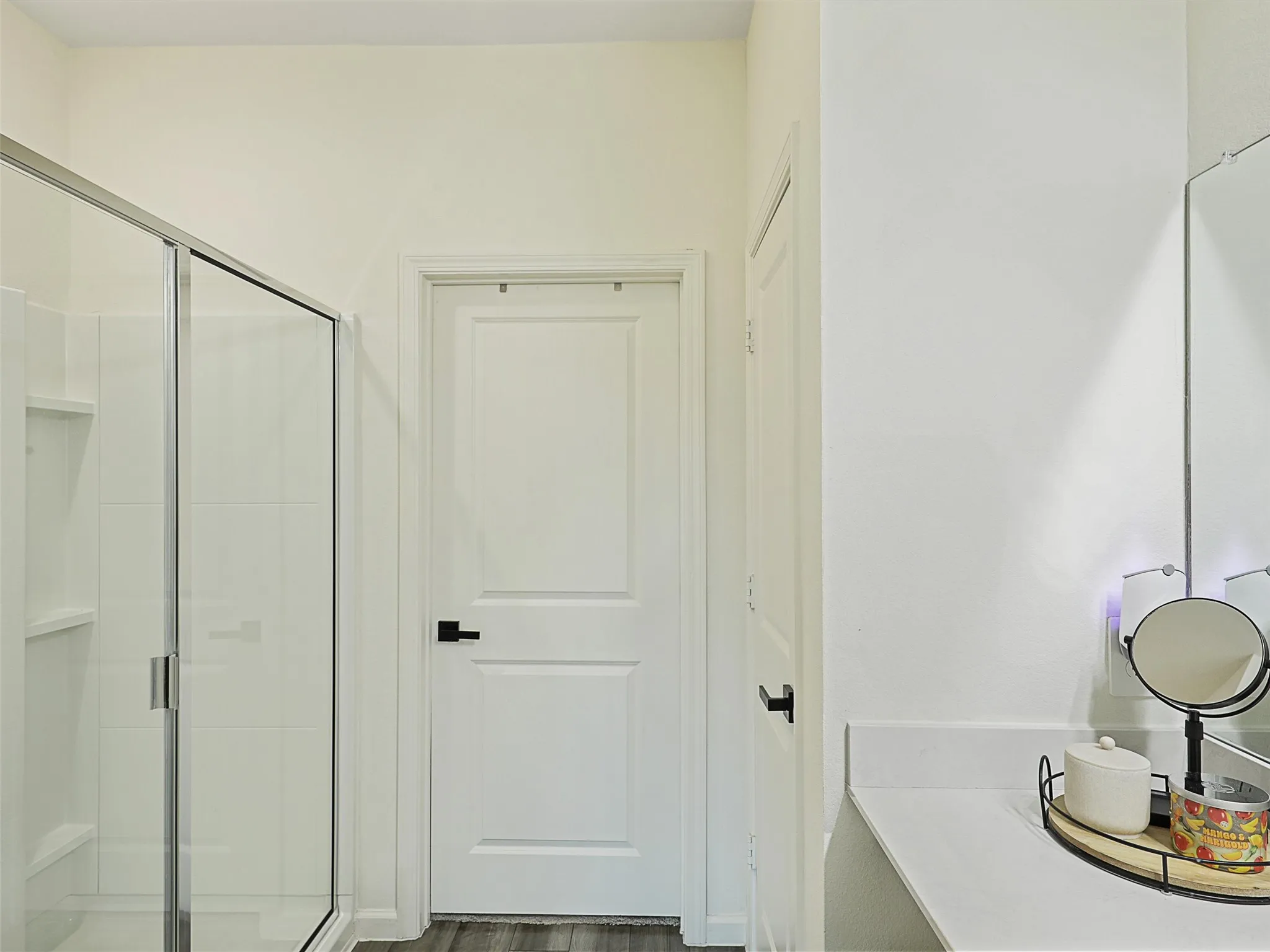 Just beyond the vanity is walk in shower.