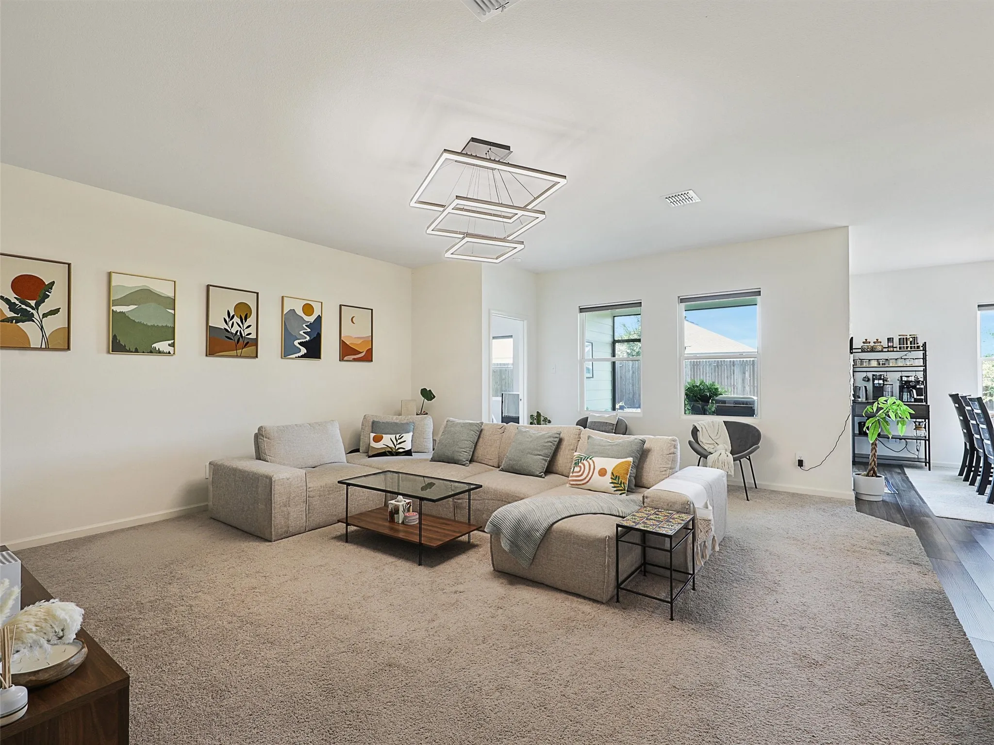 From here, the living room connects to the kitchen and dining area.