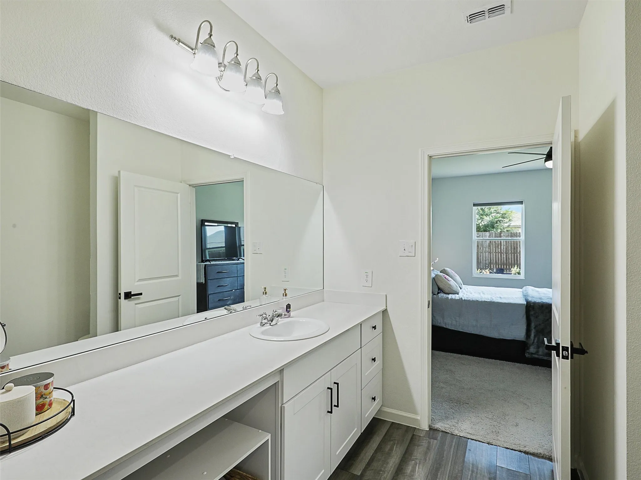 A closer look at the primary bath shows the full vanity and bathroom layout.